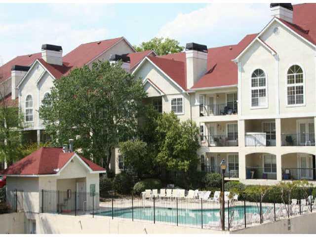 DON'T LET THE PRICE FOOL YOU! UPGRADES GALORE-END UNIT W/ GATED COVERED PARKING, BUILT-IN SHELVING, DOUBLE-SIDED MARBLE FIREPLACE, BALCONY OVERLOOKS POOL, TILE & HARDWOOD FLOORING-TOO MANY TO LIST!