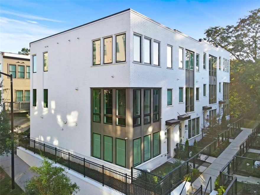 Experience elevated in-town living in this beautifully designed three-story end unit townhome, where natural light fills every level and every finish has been thoughtfully selected. The open layout features hardwood floors, 9-foot ceilings, custom window treatments, and sophisticated designer touches. A chef’s kitchen with solid surface countertops and high-end appliances flows into the dining area framed by floor-to-ceiling windows. The spacious family room is perfect for hosting, complete with built-ins, a wine cellar, fireplace, and a private balcony that extends your living space outdoors. On the lower level, a built-in office creates the ideal setup for working from home. Upstairs, the primary suite features dual walk-in closets and a spa-inspired bath with quartz double vanities, a frameless glass shower, and a private water closet. Secondary bedrooms and bathrooms are equally generous and beautifully appointed. Enjoy the added benefits of a fenced yard, Sonos sound system throughout, and a two-car garage with extra storage. Located directly on the BeltLine in Madison Yards, you’re just moments from Publix, AMC, Kilwins, Muchacho, First Watch, and more. This is the lifestyle buyers are searching for—seamless, stylish, and perfectly positioned.