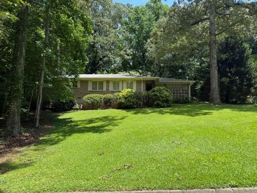Charming mid-century ranch full of character on a quiet dead-end street in East Cobb! This 4-sided brick home features 3 bedrooms, 2 full baths, and 1,508 sq ft of comfortable living space. Hardwood floors run throughout, adding timeless appeal. A fenced, lush backyard offers privacy and room to relax or play, while the 2-car carport provides covered parking and extra storage. You'll love the unbeatable location — minutes from parks, shopping, dining, and top-rated East Cobb schools. Well-maintained and full of potential, this classic home is ready for its next chapter — don’t miss it!