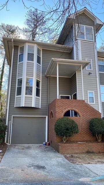 NEW PAINT THROUGHOUT INTERIOR! Updated townhome featuring 2 bedrooms & 2 full bathrooms with one car garage conveniently located off Powers Ferry Road. Galley style Kitchen features white cabinets, separate dining room, a spacious living room with a fire place. A huge storage closet downstairs and additional storage area in the 1 car garage. Included trash & lawn maintenance.