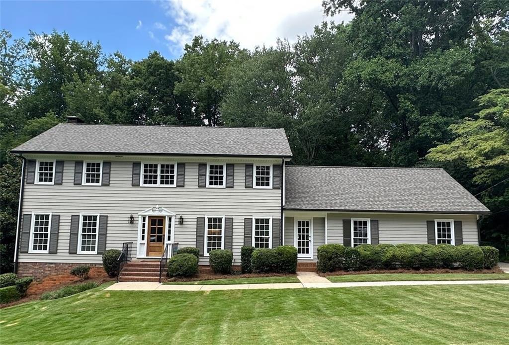 When classic Dunwoody charm meets modern-day glow-up... this house understood the assignment! This fully renovated stunner is giving luxury, livability, & just a hint of "I host the best dinner parties in town." The new kitchen? Straight-up chef's kiss — bright, open, & decked out with leathered quartzite counters, marble backsplash, Thor appliances (including a 36" gas range with a pot filler, because you’re fancy now), a dreamy island, & a walk-in pantry that’ll actually make you want to cook. Your sunny breakfast room leads to a massive party deck that runs the full length of the house — so go ahead, plan that BBQ blowout. Inside, you’ll find a cozy living room with a brick fireplace & built-ins, a “yes, finally” laundry/mudroom combo, & a powder room so stylish it deserves its own Instagram reel. BONUS: The oversized garage can handle your truck/SUV/e-bike collection with room to spare. Upstairs? Five legit bedrooms, three fab bathrooms, & a primary suite with lake views, a marble-clad spa bath, & a shower so chic it should come with a soundtrack. Hardwood floors everywhere (no mystery carpet here), including in the guest rooms. Oh, & there’s a private suite for your in-laws, teenager, or that one friend who always “accidentally” spends the night. The finished basement is chef’s kiss part two — open, versatile, & featuring a wet bar that’s serving leathered quartzite, floating backlit shelves, & a beverage cooler (aka “weekend mode” in appliance form). This basement puts the fun in Funwoody! New full bath, luxury vinyl floors, & storage galore. All the hard stuff’s done: NEW roof, gutters, HVAC, water heater, plumbing, electrical, gutters, even the front door! Tucked into a private backyard with lake views that bring all the zen. This one? It’s not just move-in ready. It’s main character ready.