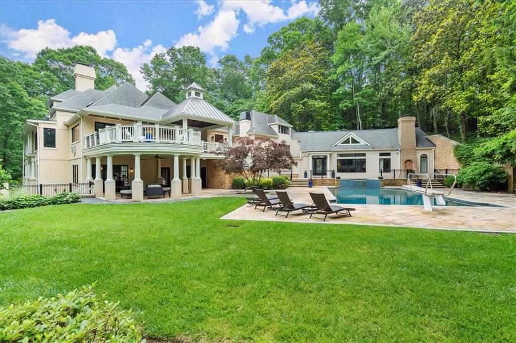 Serene riverfront estate, +/- 3.94 wooded acres, overlooking the Chattahoochee River and Cochran Shoals National Park. With sweeping seasonal views, the home itself is only matched by the beauty of its natural surroundings. A level driveway brings you to a private front entrance. Once inside, you'll find the open floor plan flows effortlessly, while custom windows & doors accentuate the natural surroundings. Detailed upgrades on the main floor include: spacious living room with custom, concrete mantle, large formal dining room, expanded Chef's kitchen with quartzite countertops, custom cabinets, & expansive island. Thermador & Bosch appliances. The primary suite offers fireplace, spacious steam shower, free standing soaking tub, walk-in closet & access to balcony. This spectacular home affords you numerous opportunities to have fun, while still escaping the hustle & bustle of the outside world. Features include: numerous decks, patios & balconies, a 12 ft deep, 66,000 gallon in ground salt water pool with adjoining pool house, & your very own launching pad to canoe/kayak the Chattahoochee River! On the terrace level you'll find: fireside gathering room, gym, bar, wine cellar, vault, bed/bath, and a two-bedroom apartment with kitchenette & separate entrance. On the top level, three en-suite bedrooms (2 fun secret areas) 3 car garage. State of the art security system. Impeccable sellers with unbelievable maintenance. Ideal for multi-generational living. Seller will consider selling the house fully furnished minus a few personal items. As such, the property would make a lovely, turnkey second home or, with the potential to rent it for over $20,000/ month, a luxury rental property for a savvy investor.
