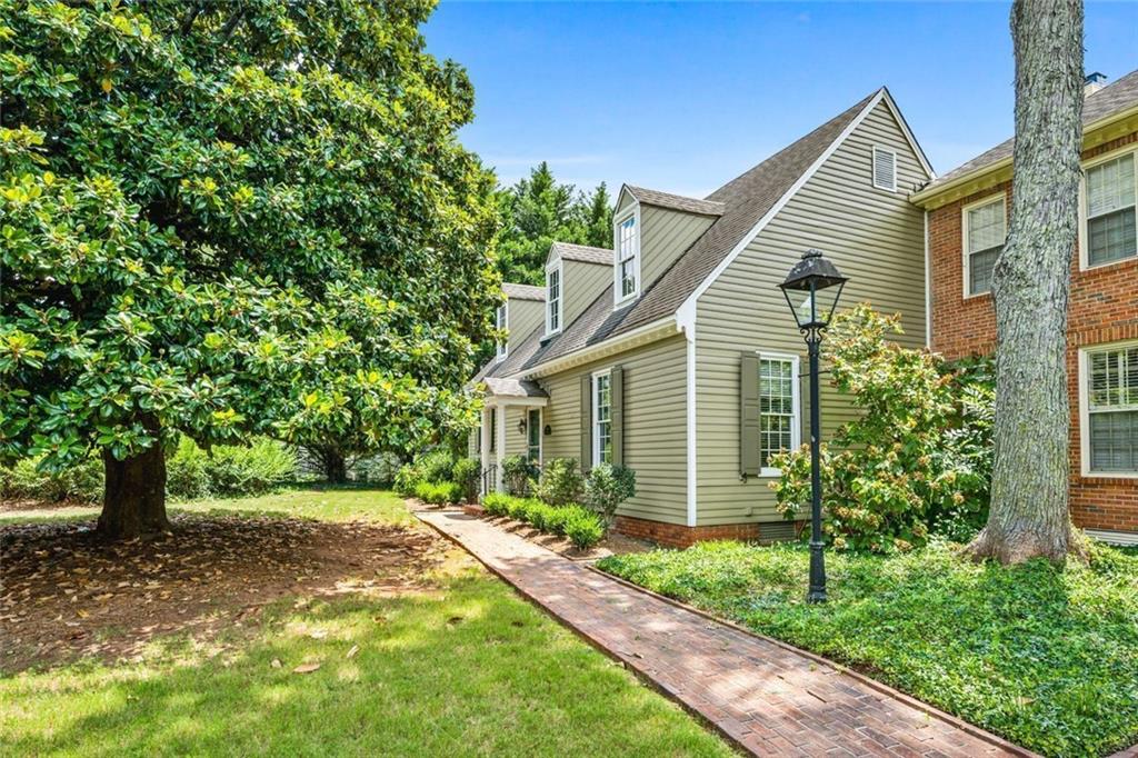 Located on one of Marietta’s most storied streets, 490 Chowning Place is a rare gem, a meticulously designed replica of Colonial Williamsburg architecture set in the heart of the Kennesaw Avenue Historic District. This beautifully updated 2-bedroom, 2-bath home offers one-level living with unmatched charm, character, and location. Inside, you'll find wide plank real pine floors, 9-foot ceilings, and an open living and dining concept anchored by a classic wood-burning fireplace. The kitchen has been tastefully updated with quartz countertops, modern appliances, and a bright eat-in breakfast area—perfect for both everyday living and entertaining. The oversized primary suite features a fully renovated bathroom with granite counters and a subway-tiled walk-in shower. Outside is a large private brick courtyard—fully fenced, lushly landscaped, and ideal for relaxing or gathering with guests. Additional features include a detached two-car garage, authentic wood siding, and a prime location near Wellstar Hospital, Marietta’s most prominent antebellum and historic homes, and all the dining, shopping, and culture of the Marietta Square. Located in a highly sought-after community, this home offers a rare blend of historic character and modern comfort—an opportunity not to be missed.