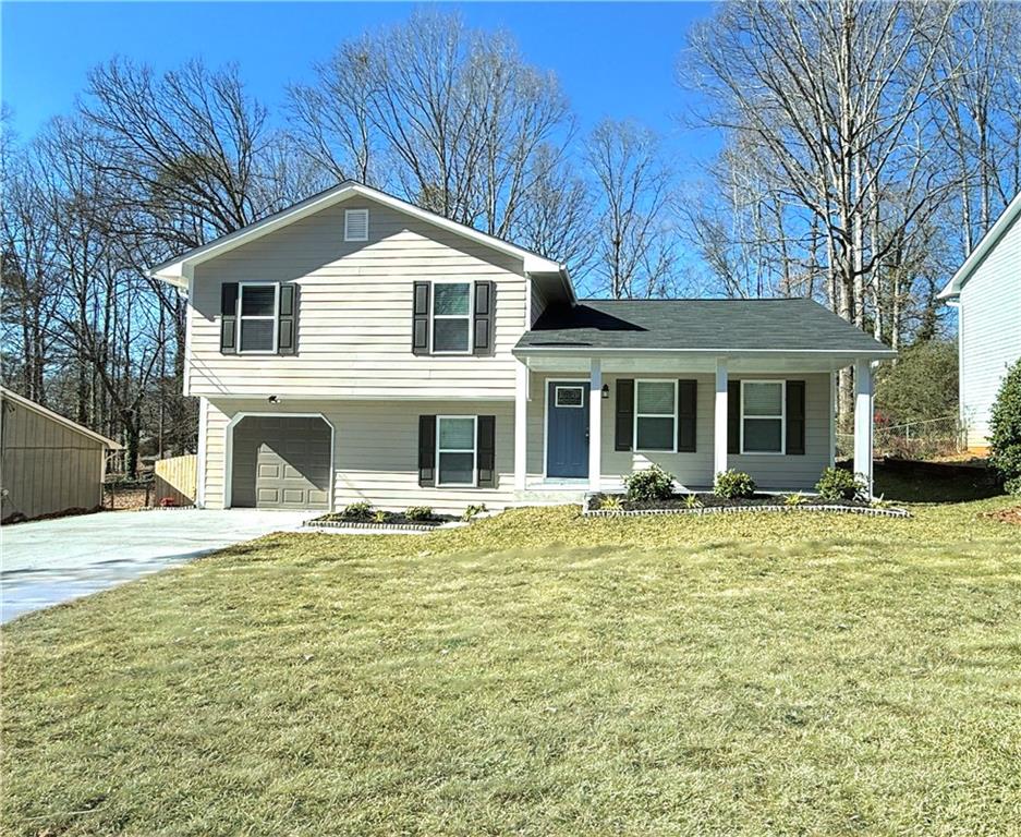 Better than new and totally renovated home located in this popular area of Ridgefield West in Lithonia GA! New open & custom kitchen with granite counter-tops, new cabinets, stainless steel appliances & breakfast bar. Separate living room & dining room. Spacious family room with fireplace. Large master bedroom with walk-in closet. All newly renovated bathrooms with new ceramic tile & custom vanities. All new systems, new roof & driveway. New double pane insulated glass windows. Beautiful new flooring throughout home. New deck overlooking very large private backyard with newly landscaped sodded lawn. New wooden privacy fence surrounds this private backyard. The price of this home is well under what you'd pay for new construction in this part of town. This is a great deal for this home & will not last long!