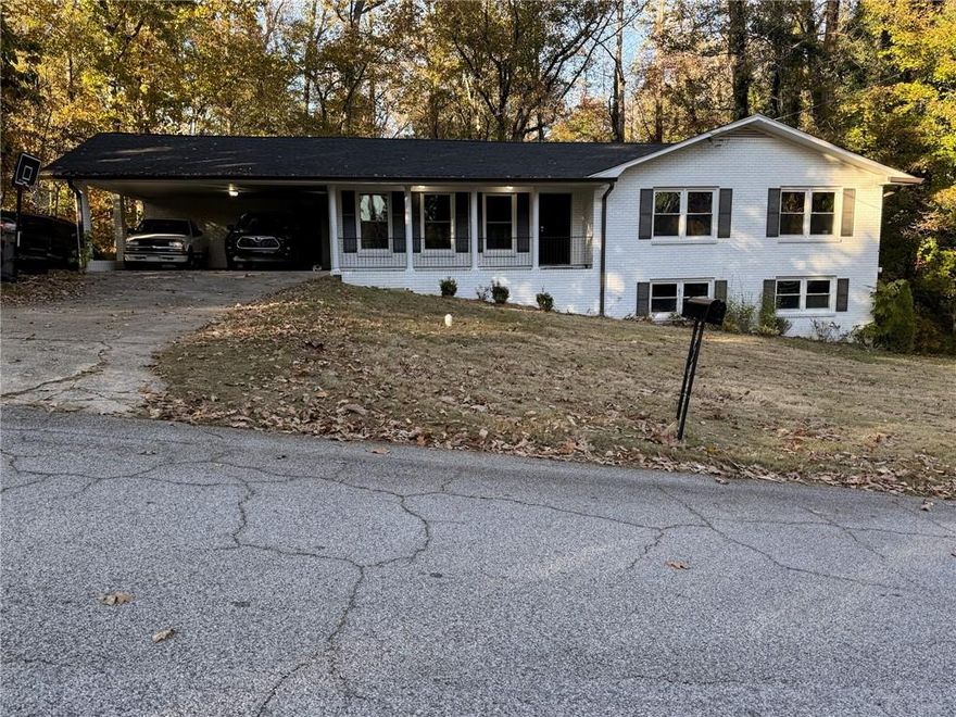 Welcome to this beautifully updated 3 bedroom, 2 bath, four-sided brick home situated on a serene 1.2-acre lot. The home underwent a thorough 2023 renovation including a new roof, new HVAC, new flooring, new kitchen cabinets, granite countertops, updated bathroom showers and vanities, modern fixtures, and a new water heater. The spacious back deck offers plenty of room for outdoor dining and entertaining, all while enjoying the peaceful wooded views.The full daylight basement is already studded and ready for your vision, offering endless potential for expansion and added value! Enjoy being just minutes away from all the dining, shopping, and entertainment in downtown Douglasville. Don't miss out! Schedule a showing today!