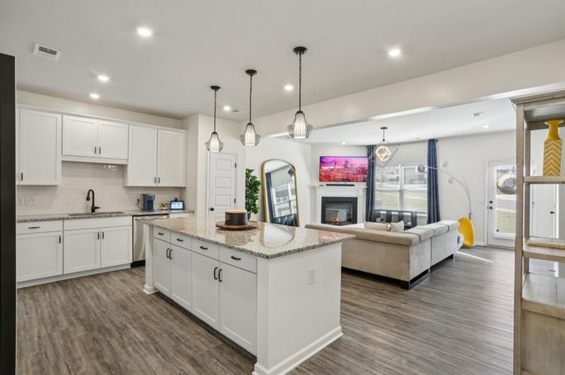 Welcome to this Immaculate End Unit Townhome in the Sought-After Concord Community, right in the Heart of Woodstock! Tucked perfectly between Downtown Woodstock, Roswell, and Milton, this home offers Prime Location with everyday Convenience. Step inside and you'll be greeted by tons of Natural Light pouring through Large Windows, highlighting the Open Concept Living Area with Gorgeous Hardwood Floors and Stylish Finishes throughout, perfect for a relaxing night or entertaining guests. The Eat-In Kitchen is a true Showstopper - complete with a Large Island, Stainless Steel Appliances, Quartz Countertops, White Cabinets, and Tons of Storage. A thoughtfully placed Powder Room finishes off the main level. Upstairs, the Primary Suite is the perfect Retreat. Enjoy a Spacious Bedroom, a Spa-Like Ensuite Bathroom with a Soaking Tub, Separate Walk-In Shower, Dual Vanities, and a Huge Walk-In Closet. Two Additional Bedrooms offer Flexibility for a Home Office, Guest Room, or Family Space, and they share a Full Bath. The Two-Car Garage provides Extra Storage and Shelter for Your Cars Year-Round. Neighborhood Perks like Sidewalks, Street Lights, and Dog Stations give it that Welcoming, Community Feel. Just minutes from Shops, Grocery Stores, Entertainment, and Top Schools - this home checks all the boxes for Comfort, Style, and Location. Don't miss your chance to live in a space that's more than just a home - it's a Lifestyle.