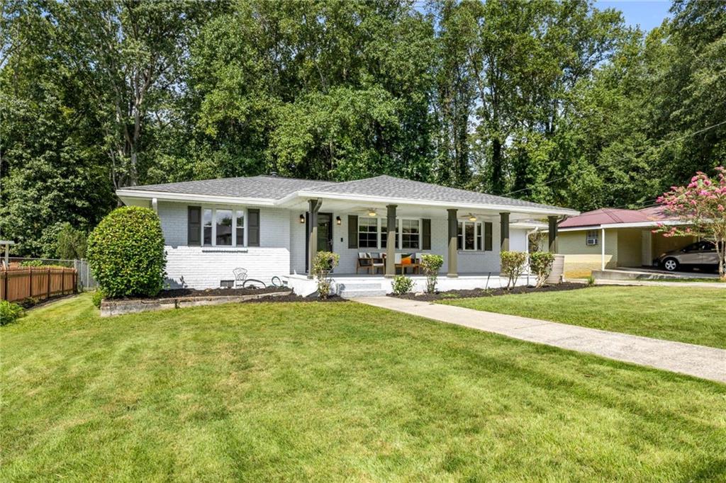 Welcome to this charming brick home in the highly sought-after West Smyrna Village neighborhood, ideally located close to shopping, restaurants,
and The Battery/Braves Stadium. From the moment you arrive, the inviting covered rocking chair front porch sets the tone for this warm and welcoming
property. Inside, you’ ll find hardwood and tile flooring throughout—no carpet anywhere—and fresh neutral paint that provides a move-in ready feel. The home
offers a versatile floor plan with a separate living room, separate dining room, and an incredible family room addition that opens seamlessly to the
kitchen. The spacious kitchen features granite countertops, stainless steel appliances, a tile backsplash, ample breakfast bar seating, and a large eat-in
area, providing plenty of space for gatherings. A half bath is conveniently located off the main-level laundry room, while the full bath features classic
tile finishes. With three bedrooms, 1.5 baths, and a large unfinished basement/workshop area with a painted floor and full walkout door, this home
offers both comfort and potential. Outdoor living is equally impressive with a back deck overlooking the expansive level fenced yard—complete with irrigation
system, plenty of room for play or a future pool, and a cozy fire pit area. This move-in ready home combines space, style, and location—all while being
minutes from everything Smyrna has to offer.