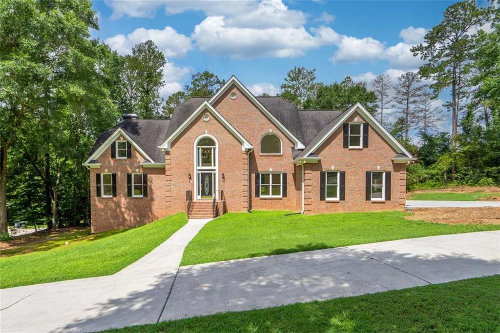 Welcome to this beautifully updated brick home nestled on 2.39 acres in charming Oxford, Georgia. Step through the dramatic two-story foyer and be greeted by an open, airy floor plan that exudes timeless elegance and modern flair. New LVP flooring flows throughout the main level, creating a sleek and cohesive feel. Entertain with ease with the formal dining room-perfect for hosting holiday gatherings and dinner parties. The space flows seamlessly into the soaring two-story great room, featuring a fireplace and access to the rear deck, ideal for indoor/outdoor living and entertaining.The chef's kitchen is a dream come true, complete with quartz countertops, shaker-style cabinetry, brand-new stainless steel appliances, and abundant prep and storage space and a breakfast area. Just off the kitchen, is a cozy family room with a fireplace. A stylish main-level powder room features updated fixtures, cabinetry, and quartz finishes and also located on the main is a spacious laundry room that has new cabinets with quartz and a utility sink.The main-level owner's suite is a serene retreat with its own fireplace, a spa-inspired ensuite bath featuring a freestanding soaking tub, marble tile flooring, a luxurious walk-in shower, and double vanities with quartz countertops. Upstairs, a catwalk-style hallway overlooks the great room below, creating striking architectural views. One of the upstairs bedrooms features its own private en-suite bath, while two additional bedrooms share a connected full bath with dual quartz vanities and stylish finishes. A spacious bonus/flex room-complete with a charming oval window-offers the perfect space for a playroom, office, or media room.The full daylight basement is unfinished and stubbed for a bathroom, providing ample potential for future expansion. With fresh interior and exterior paint and new carpet upstairs, this home is truly move-in ready. Don't miss your chance to own this exceptional home that blends luxury, comfort, and convenience-all just minutes from Covington and Conyers, schools, shopping and more.