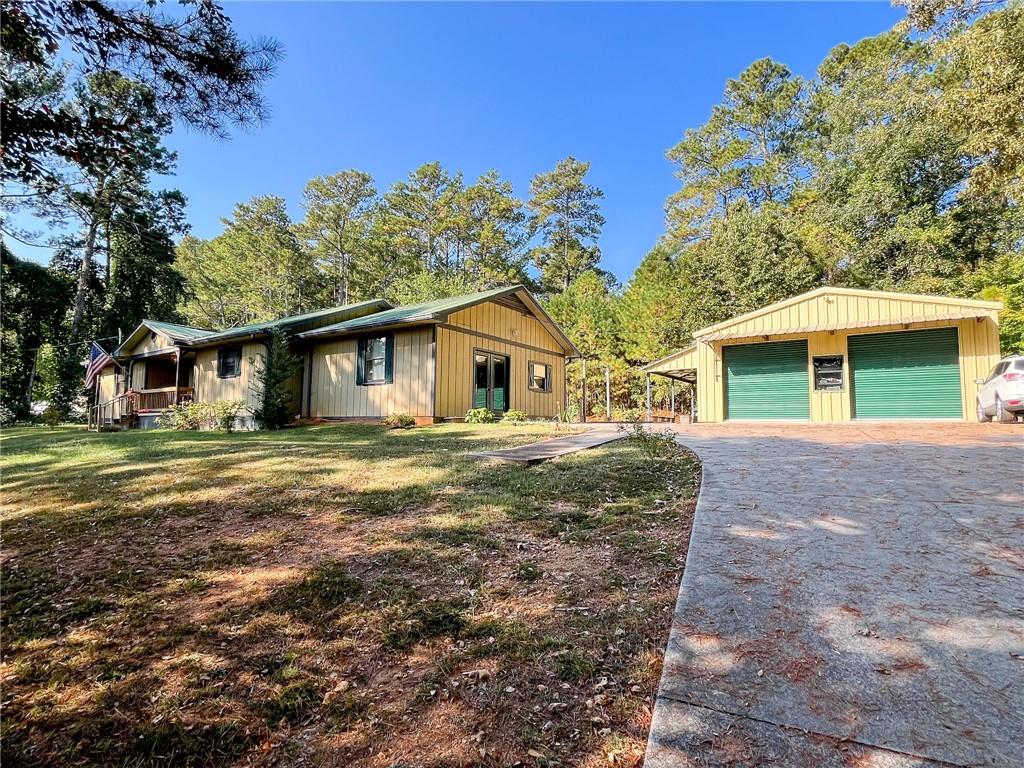 Welcome home to your own backyard retreat just minutes from Adairsville schools and conveniences. Set on nearly an acre, this inviting 4-bedroom, 2-bath ranch blends comfort, charm, and plenty of extras. Inside, hardwood floors and warm wood accents set the tone for cozy living. A wood-burning stove adds rustic character, while French doors in the living room open to a large screened porch, the perfect spot for morning coffee or winding down after a long day. The updated bathrooms offer fresh style, and the split-bedroom layout provides privacy for the spacious owner’s suite. Out back, the lifestyle really shines. A sparkling in-ground pool becomes the centerpiece for summer fun, while the expansive heated 24x30 garage doubles as a workshop/party barn. With dual roll-up doors, power, insulation, and plenty of flexibility, it’s ready for work or play. The shop is stubbed for water as well. An additional storage shed, established garden area, and a whole-home Generac generator add everyday convenience and peace of mind. Topped with a durable metal roof and screened gutters, this property is built for low-maintenance living. Whether you’re entertaining poolside, tinkering in the workshop, or simply enjoying the privacy of nearly an acre, this home offers a laid-back lifestyle with room to spread out. Don’t miss your chance to see all that this Adairsville retreat has to offer!