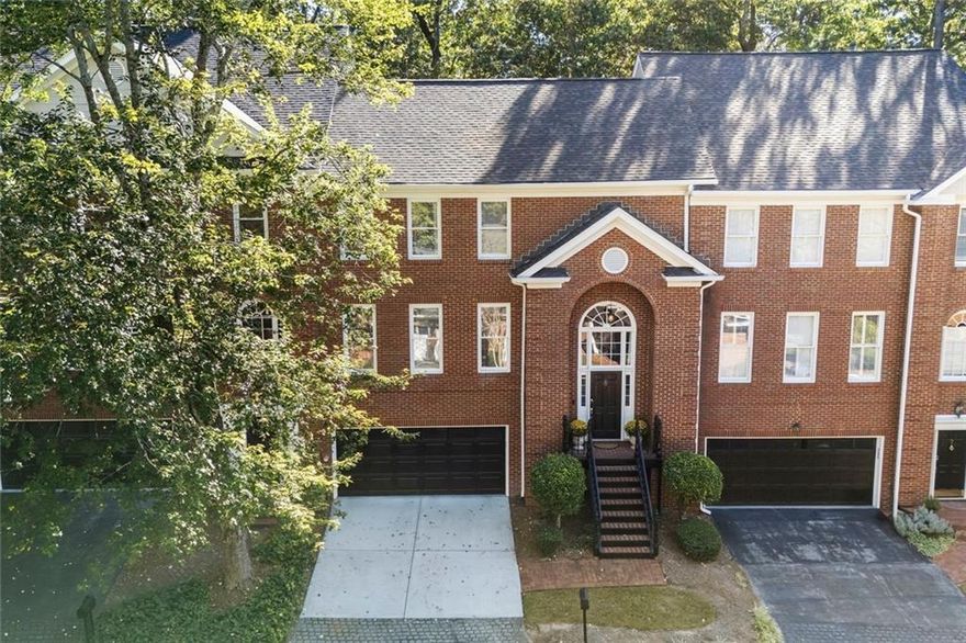 Spectacular Luxury Townhome in Sandy Springs! Beautiful architectural details are found throughout this three-level brick home in the gated Wyngate at Spalding community. It offers 2 Bedrooms on the upper floor and a large Office/Bonus Room on the lower level that is perfect for a Guest Bedroom. The Main Level features an amazing Gourmet Kitchen with high-end finishes, including a spacious island with designer recycled-glass and quartz surfaces, custom cabinetry, premium Bosch and LG appliances, a Zephyr beverage cooler, and an LG Smart Wi-Fi Enabled Double Oven Gas Range. The Dining Room includes custom built-ins overlooking a private, fenced backyard with an expansive stone patio—ideal for entertaining, relaxing, pets, or gardening. The Primary Suite features a spa-like retreat with a soaking tub and a custom large stone-tile shower with built-in niches for shampoo and essentials, complemented by natural stone heated floors. Additional highlights include 9-ft ceilings, transom windows, luxury vinyl plank flooring, and an oversized two-car Garage with generous storage. Wyngate at Spalding is a friendly gated swim/tennis/pickleball community minutes from Dunwoody Village, Sandy Springs City Center, and GA-400.