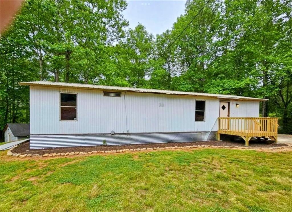 Rental Machine or Lakefront Dream! This 3 bedroom, 1 bath modular home sits just steps from the water and offers unbeatable lake views. The main home features 670 sq ft of living space, plus an enclosed rear porch that adds an additional 288 sq ft—perfect for a third bedroom, extra storage, or expanded living. Whether you're looking for a weekend getaway, full-time retreat, or short-term rental opportunity, this home is brimming with potential. Enjoy year-round comfort with a mini-split HVAC system, and take advantage of the spacious shed out back on a concrete slab—ideal for storage or even a future build-out. Bring your vision and your canoe! With some TLC, this lakeside gem could be transformed into a cozy escape or cash-flowing rental!