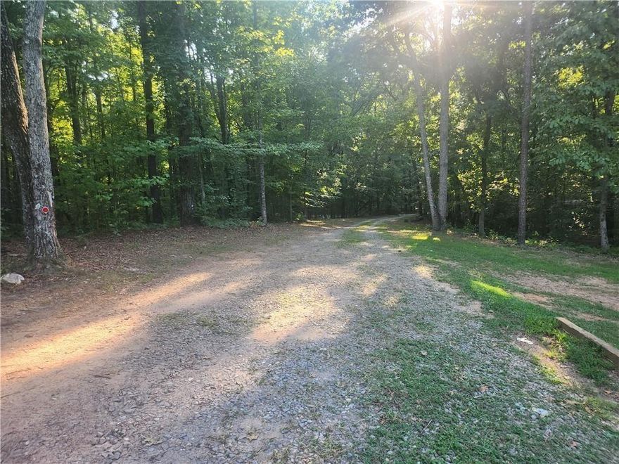 Best priced property anywhere in this area. Private, secluded. Lake view. Most sought after school district in Cherokee County. Minutes from Milton/Fulton County with cheaper taxes. Situated between prestigious Woodmont Country Club and Old Lathemtown Road properties. For sale sign is on the easement to tract 6 & 7. See plat in pictures. An easement appurtenant is a specific type of easement that attaches to a particular parcel of land, benefiting or burdening that land's use. Unlike easements in gross, appurtenant easements are linked to a specific dominant estate (the property that benefits) and a servient estate (the property burdened by the easement). This means the easement passes with the transfer of ownership of the dominant estate, and the burdened property continues to be subject to the easement, regardless of ownership changes according to legal sources.