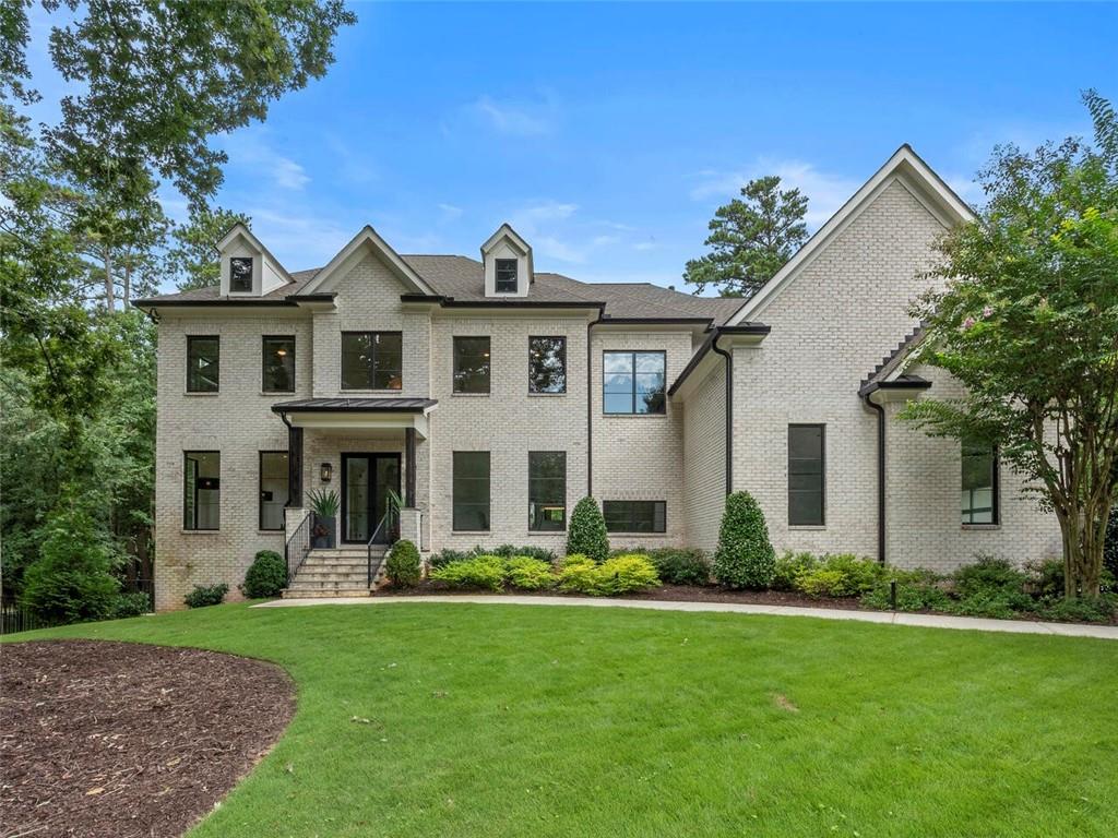 Flawlessly designed Chastain Park home features an interior showcasing an inspired pairing of natural elements and contemporary architectural details including metal windows and doors, wide-plank hardwoods, detailed millwork, and unique statement lighting. A bright, airy layout creates the ideal backdrop for a seamless indoor/outdoor lifestyle anchored by the smartly configured kitchen outfitted with a suite of premium appliances, Quartz countertops, and custom beaded inset cabinetry. Vaulted keeping room and living room opens to the covered Bluestone patio with skylights and a fireplace overlooking the heated saltwater pool and backyard. Oversized upper-level primary suite features a striking ledger stone-clad fireplace, morning bar, massive closet room, and stunning bath with dramatic open shower, luxurious soaking tub, and dual floating vanities. Daylight terrace level offers a tiered media room, game area, and private guest suite. Highly sought-after location, minutes to Chastain Park, Buckhead, and Sandy Springs.