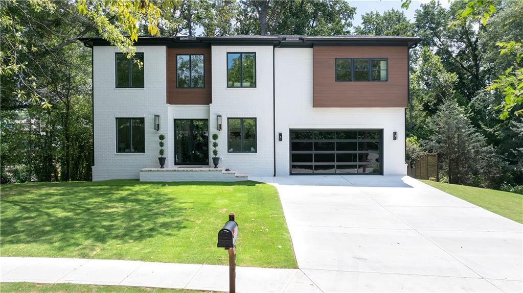 Nestled in the heart of downtown Smyrna, this stunning new construction home offers 6 generously sized bedrooms, 4 full baths, an expansive lot, and curated upgrades that exude modern luxury. From the oversized gas lanterns that beckon you home from your walk to the Market Village, to the stacked square edge on the Taj Mahal quartz that spans throughout the entire main level, this home is truly an extraordinary opportunity! Enter the two-story foyer with an impressive staircase that leads to the wrap-around second level catwalk and unique balcony-style bonus space. (Do I even have to mention the glass front doors and tinted garage doors that complement each other?!) The main level boasts 10-foot ceilings and features a light-filled mudroom, front bedroom, and a gorgeous bathroom complete with custom fluted white oak vanity. Of course there’s the open-concept living room, dining room, and custom kitchen outfitted with statement lighting and floor-to-ceiling white oak cabinetry. Designed for effortless entertaining, step outside from either the dining room or living room onto the covered deck that wraps from the private backside to the far side of the home. Upstairs you’ll find the primary retreat complete with museum-style picture lighting, an enormous walk-in closet with views of the tree-lined backyard, and the ensuite bathroom of your dreams! There you’ll also find 3 guest bedrooms (one complete with balcony-style bonus space), one of two convenient laundry rooms, and a shared bathroom, all boasting 9-foot ceilings and the same 5-inch white oak hardwood flooring as you’ll find on the main level. Downstairs features a fully-finished terrace level that can be utilized to your heart’s desire! One room has been finished with a media space in mind, while another large space screams bonus room OR second living room for an in-law or teen suite! The second laundry room is downstairs as well. Just off of the bonus room is the roomy 6th bedroom with gorgeous ensuite bath, and a walk-out covered patio perfect for enjoying the backyard view. The backyard has been leveled and sodded here off the patio - ready for all of the backyard games or even a future pool site! Welcome to an absolute gem in the heart of the Jonquil City! With year-round walkability to dining, shopping + community events, no HOA, and brand-new construction, this home offers the ultimate blend of modern luxury, community, and convenience. Co-agent Frieda is related to seller.