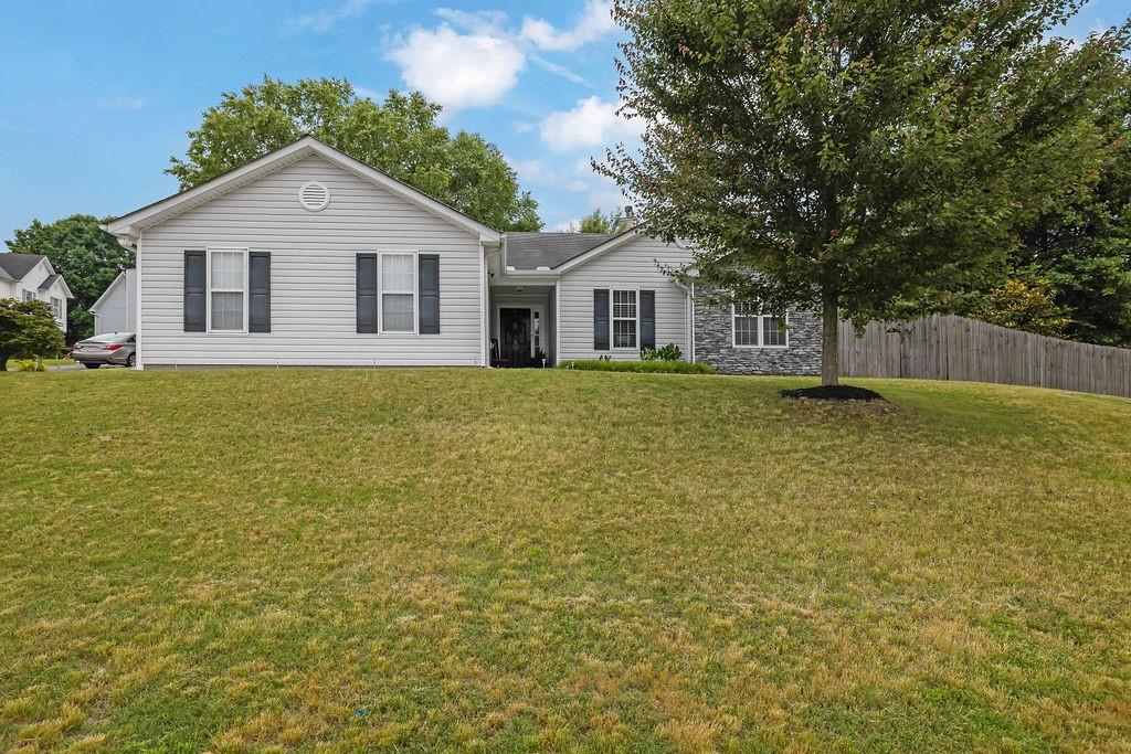 Welcome to this immaculately maintained 3-bedroom, 2-bathroom home, nestled on a corner lot in a highly desirable neighborhood, with no HOA! Conveniently located in proximity to Interstate 575, shopping, dining, and entertainment. From the moment you step inside, you’ll appreciate the clean, neutral paint palette, hardwood flooring, and vaulted ceilings that create an open, airy feel in the main living space. Built-ins and a cozy wood-burning fireplace are featured in the living room, offering both charm and practical storage. The functional kitchen is updated with solid surface countertops and backsplash. The primary bedroom is a peaceful retreat with a tray ceiling, spacious layout, and an ensuite bath that includes a separate soaking tub and shower for ultimate relaxation. Set up your office/study or home gym in the bonus room. Step outside to enjoy the landscaped backyard, complete with a patio and fire pit—perfect for entertaining or quiet evenings outdoors. Privacy and security are provided with the fenced-in yard, making it ideal for pets, play, or gardening. Newer water heater, newer appliances, and a newer heating and air conditioning system will provide peace of mind for years to come. This home is truly move-in ready and located in a well-kept neighborhood that reflects pride of ownership throughout. Whether you’re a first-time buyer or looking to downsize, this property checks all the boxes. Square footage reflected in Tax Records is not accurate. Don’t miss your chance to own this delightful home—schedule your showing today!