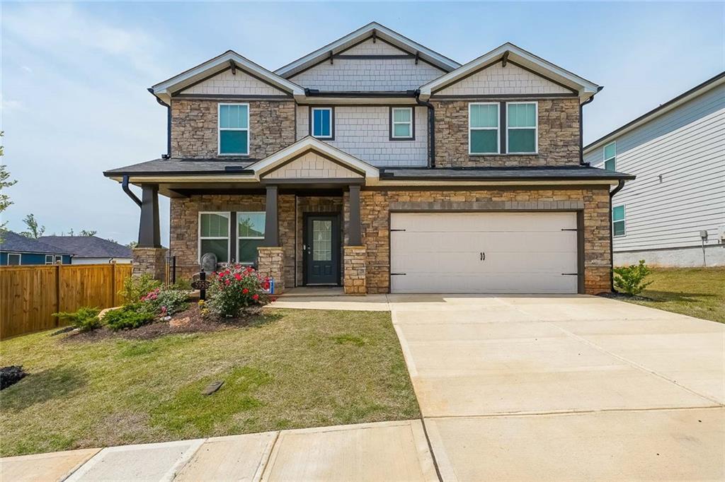 Imposing, like new, stoned fronted, move-in ready, energy efficient 3007 sq ft 5BR 3 FULL BATH home with large privately fence backyard. Home has natural lighting throughout as well as neutral color. The main level has a uniquely-placed flex room that can serve as a formal dining room, home office, additional bedroom or a meeting room. A chef’s kitchen is enhanced by marble countertops and stainless steel appliances while a large walk-in pantry, and a sliding glass door opens to a large fenced landscaped backyard. Across from the kitchen/dining area is a spacious living area, with a log burning fireplace. This makes the main floor perfect for entertaining. On that same floor is a bedroom with a full bathroom making it convenient for guests. Upstairs, an oversized loft provides flexible bonus space suitable for a gameroom, a media room, play area or office/s. The master bedroom also upstairs features a spa-like soaking tub and a large walk-in closet. Three additional bedrooms are on the upstairs floor. The home is close to schools, churches, steakhouses, restaurants, pharmacies, schools, Buford Mall, places of worship, Kroger, Publix, etc. It is also a few minutes from medical facilities like Piedmont Healthcare Systems, Northeast Medical center, movie theatres, Lake Lanier, etc. All personal property is excluded.