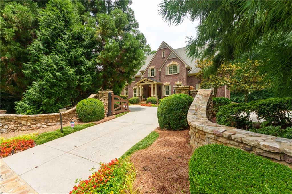 Fabulous property presents an unparalleled opportunity! The sale includes the meticulously maintained residence + the adjacent 3.09-acre lot. This strategic inclusion brings the total acreage of the private and exclusive property to a magnificent 5.25 acres, accessible thru two gated entrances, providing extraordinary flexibility and potential. Create a family compound, sports facilities, or hold onto three acres for the future. The grounds feature custom landscaping with intricate designs, extensive walking paths, and full irrigation system that keeps the property vibrant year-round.
The interior of the home is in excellent condition reflecting meticulous care, timeless details and fine craftsmanship.
The study features two full walls of built-in book cases, a handsome coffered ceiling, and detailed millwork, plus private access to the main floor primary suite. Natural light floods the dining room, with easy access from the foyer and the kitchen.
The kitchen features custom cabinetry, center island with storage and counter seating, professional appliances, and a bright breakfast area with access to the back porch. The keeping room is warm and inviting with a tall stone fireplace anchoring a wall of intricately detailed shelves. Huge windows and a wood-lined vaulted ceiling draw your eye upward and out over the serene wooded lot.
The formal living room has built-ins surrounding a stone fireplace with a detailed mantle, coffered ceiling, and easy access to the back porch. A main-floor laundry room, 2 half baths, and a 3-car garage are conveniently located on the mail level.
PRIMARY SUITE - - Main level primary suite with high ceilings and plenty of room for a seating area, a full ensuite bath with double vanities, and a large closet/dressing room.
UPPER LEVEL - A spacious common area includes access to bedrooms, upstairs laundry, and a light-filled gem of a private office with built-ins. Plus 4 large bedrooms, each with ensuite bath and walk-in closet - one is large enough to be a second primary suite.
TERRACE LEVEL - This level has direct access to a lawn that provides abundant space for the future addition of a luxurious swimming pool! Multiple recreation areas include large open spaces for game tables and seating, a wet bar with a full-size fridge, media room for movie nights, and a double home gym! An extra guest room has an ensuite bath and access to the backyard.
City of Sandy Springs will soon add additional sidewalks along Powers Ferry Rd, providing even easier direct access to Chastain Park. This is an exceptional opportunity for a discerning buyer to acquire a substantial, double-lot acreage in a prime and highly sought-after location, offering both immediate luxury and significant future potential.