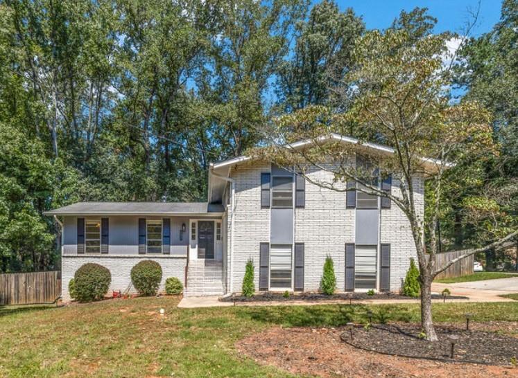 GORGEOUS 4 Level, 5 bed/ 3 bath Home with Chef’s Kitchen & Designer Finishes in Atlanta GA! Stunning chef’s kitchen, featuring a 48” 8-burner gas range with industrial hood, pot filler, oversized 8’ island with black leathered quartz, built-in beverage station with wine fridge and an 11’ vaulted walk-in pantry. Quartz counters and backsplash extend to the ceiling for a sleek finish! Serene primary suite boasts 11’ vaulted ceilings, spa-like owners bath with double vanity, LED mirrors, walk-in shower, smart toilet, W/D hook-ups and an oversized two-sided closet with built-ins! both upstair secondary bedrooms feature vaulted ceilings, custom bookcases and ample storage. The spacious living room offers a fireplace, built-ins, a stylish bar with storage & lighting, and a secret door to the lower level- perfect for an added sense of privacy, secure spaces, or a fun surprise for guests! The fully finished lower level offers two additional bedrooms, a full bath, gym/flex space, laundry and barn doors for added style. This home is complete with refinished hardwood floors on upper levels & LVP on lower, adjustable can lights, new fans, abundant built-ins, and thoughtful upgrades . Enjoy the fully fenced backyard with multiple outdoor areas designed for both relaxation and entertaining. A two-level deck & private patio located beneath the kitchen deck — a perfect shaded retreat. New furnace & termite warranty in 2023. Move-in ready and FULL of high-end touches. NO HOA. Welcome Home!