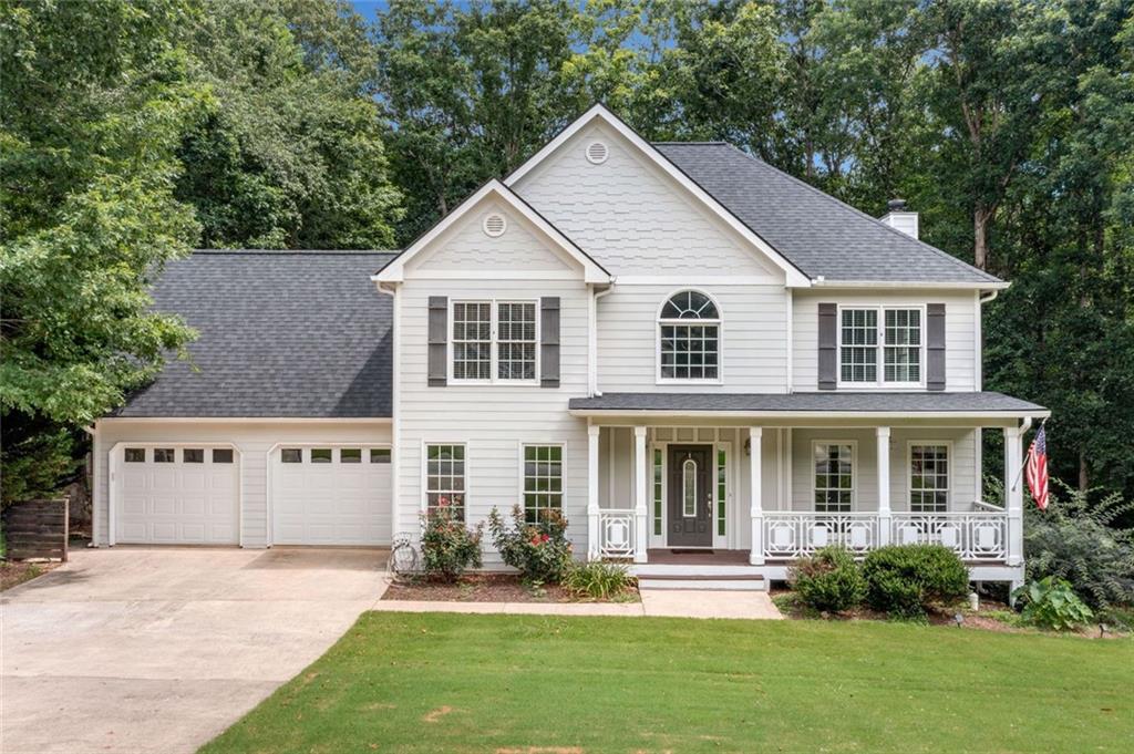 Welcome to this charming home nestled on a generous 0.8-acre wooded lot surrounded by greenspace. You'll appreciate the quiet privacy and natural beauty the moment you arrive. Kitchen-level parking makes life easier, and the covered country front porch is the perfect spot for morning coffee or relaxing at day’s end.
Step inside to find stunning hardwood floors on the main level and a dramatic two-story foyer that floods the space with light. The open floorplan connects the living areas with ease. The kitchen features a bright eat-in space, breakfast bar, and mobile island for flexible prep or serving. A formal dining room nearby adds an elegant space for gatherings.
Upstairs, the spacious primary suite offers a true retreat with a large walk-in closet. You’ll also find a large upstairs laundry room with a utility sink for added convenience. All secondary bedrooms are spacious. There's also a standout guest or in-law suite. It rivals the primary suite with its large bedroom and private full bath.
Upstairs, you'll find four bedrooms and three full bathrooms. This setup makes it easy for guests or multi-generational families to stay comfortably.
Step out back to a private rear deck that overlooks a large fenced backyard—perfect for entertaining, gardening, or play. The full unfinished basement offers endless possibilities to expand or create the space you’ve always wanted.
This home blends thoughtful design with flexible living in a peaceful setting. Come see the comfort, charm, and potential this property has to offer.