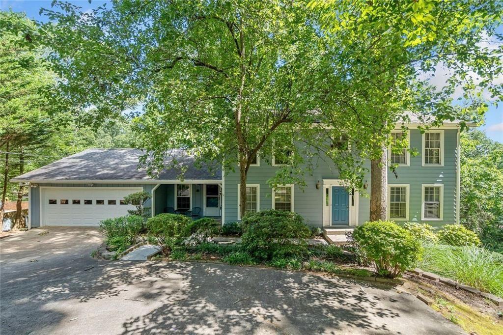 Welcome home to this spacious traditional home located in a highly desired area, convenient to Kennesaw College with no HOA. This 6 bedroom, 5 bath home would make for a great home for a large family or college students attending Kennesaw State. Step inside to a classic layout with the kitchen featuring an island with lots of cabinets as well as a breakfast area and formal dining room providing a functional layout for everyday cooking or entertaining. The heart of the home is the cozy den featuring a gas log fireplace and the large sunroom with panoramic windows perfect for enjoying your morning coffee. A large primary suite is located on the main floor with a cozy sitting area, an updated ensuite bath with a double vanity, walk-in tiled shower and walk-in closet. A full bathroom on the main floor provides convenience and privacy for visitors. Upstairs, you will find another expansive primary suite with a cozy sitting area, an ensuite bath with a shower, and double vanity. Two additional bedrooms are located upstairs with each having a full bath. The finished terrace level includes a large den, two bedrooms, an office, workshop and storage with exterior entry to a deck and backyard that is cleared and level with additional parking. The home sits on a double lot perfect for enjoying outdoor gatherings. This home is the perfect blend of space, style, and location with easy access to I-75 and 575 and lots of shopping and numerous dining options just minutes away.