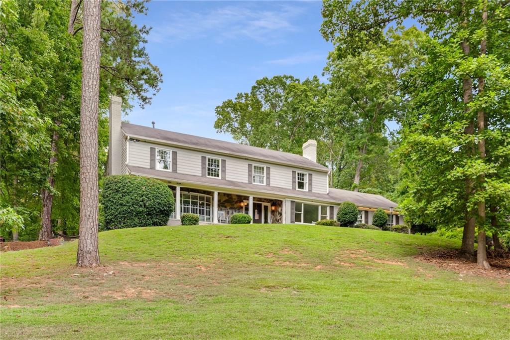 Located in the heart of Sandy Springs, 2660 Spalding Drive offers 4 bedrooms, 3.5 baths, a finished basement, and a spacious layout ideal for comfortable everyday living and entertaining. A large formal living room just off the foyer sets the tone—perfect for guests or flexible enough to open to the kitchen. The sunroom provides a quiet retreat with views of the private, landscaped backyard. The bright white kitchen features an island, breakfast nook, and flows seamlessly into the open dining area. The cozy family room is filled with natural light and anchored by a fireplace. Upstairs, you'll find the owner's suite with a walk-in closet and a double vanity bath with a walk-in shower, along with two additional generously sized bedrooms—each with access to its own bathroom—and a convenient laundry room. The finished basement includes a full bedroom, providing ideal space for a guest suite, media room, or home office. Outside, enjoy a patio and large backyard—perfect for relaxing or entertaining. All just minutes from Dunwoody Village’s shops and restaurants, with easy access to GA-400 for commuting or weekend getaways.