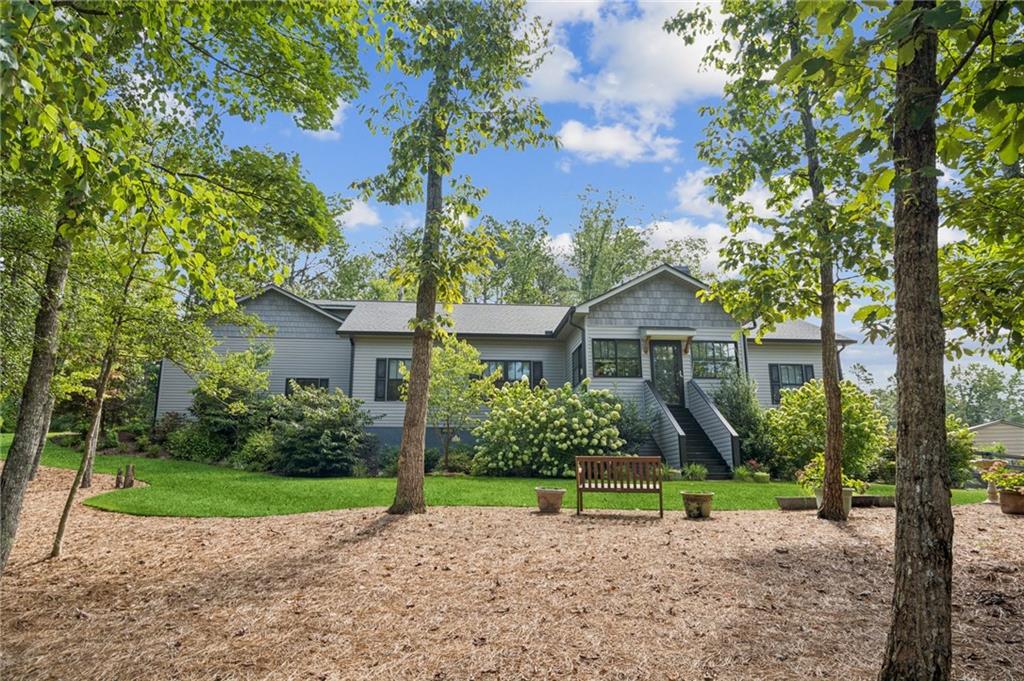 Back of property with a yard and stairs