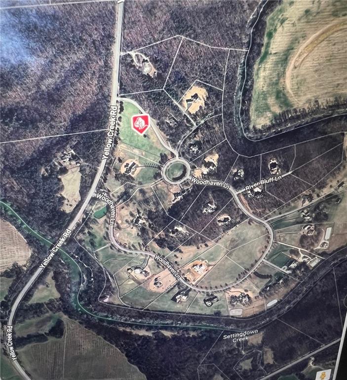 Gorgeous 6.4 acre pasture estate lot waiting to welcome you and your builder. Woodhaven Bend is a gated sanctuary of 32 custom estate home sites located on the Etowah River. This peaceful community offers walking and riding trails, a boat ramp for access to the Etowah River, and beautiful rustic pavilions along the nature trails for community events and enjoyment. Centrally located near Ball Ground, Canton, Woodstock, Milton, Cumming, and Dawsonville. Come and see this beautiful lot and community to build your dream home.