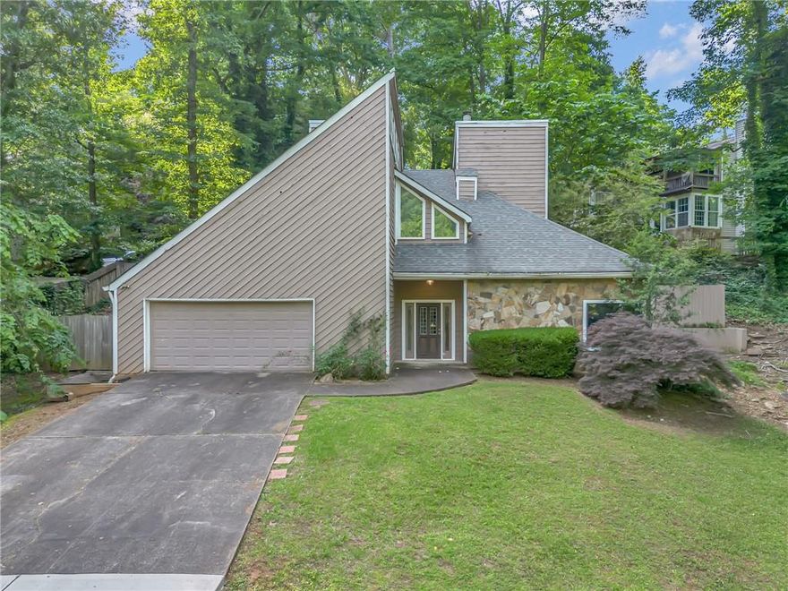 260 Lamplighter Ln SE, Marietta, GA 30067 is ready for you to make it your own! Nestled on a serene 0.54-acre lot, this beautiful 3-beds/2.5 baths SFH is surrounded by lush trees and nature views from every angle. Faturing a welcoming living room with a cozy fireplace, a spacious kitchen with direct outdoor access and a formal dining room—perfect for entertaining. The spacious master bedroom features vaulted ceilings, abundant natural light, and a bonus loft area ideal for a reading nook, creative studio, or extra storage. The two additional bedrooms also offer direct access to the outdoors, creating a peaceful retreat feel throughout the home. A back deck and attached garage add to the comfort and functionality. While this home is full of charm and natural beauty, it does need some investment—making it a fantastic opportunity to add your personal touch and build equity in a quiet, nature-rich setting.