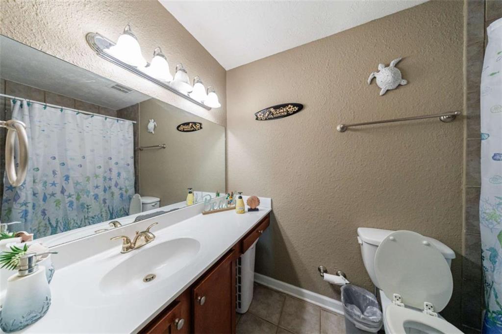 Beautiful move in ready and townhome in great location. Gated community, minutes from Historic Roswell, Parks, Chattahoochee River, etc and very convenient to GA400. Beautiful handscraped hardwoods on main level. Granite countertops and stainless steel appliances. Front loading stackable washer/dryer included. Roommate plan upstairs with own private bath, tiled floors and tiled showers. New a/c system just installed. Community offers swimming pool, dog park, tennis courts, workout facility. Water and trash included in HOA fee.