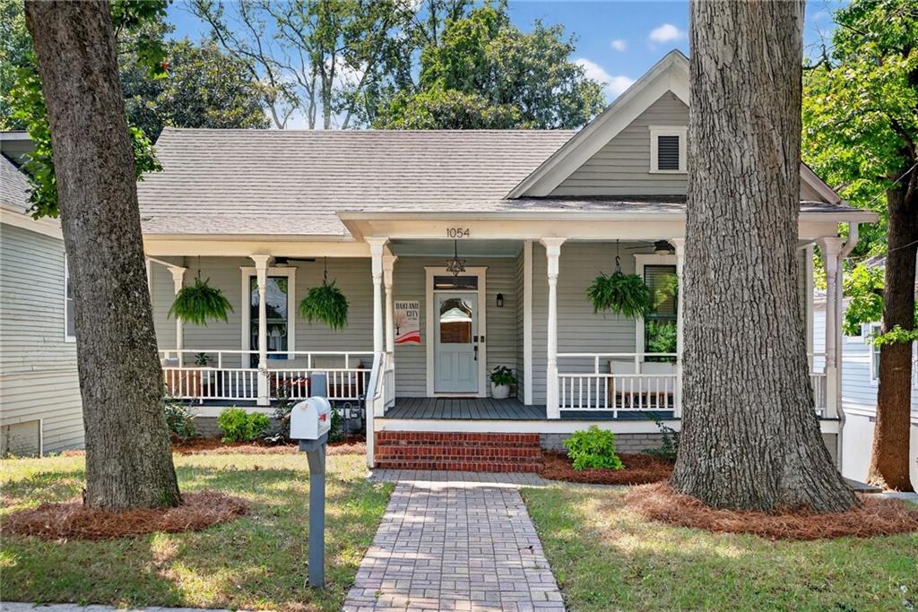 Welcome to this beautifully updated Queen Anne, where historic charm and thoughtful updates meld to create a home that feels both timeless and wonderfully livable. The inviting front porch leads inside to spacious, light-filled rooms with tall ceilings, custom millwork, and hardwood floors that run throughout.
The kitchen is designed with both style and function in mind. A Bertazzoni 36" range, French door refrigerator, and drawer microwave pair seamlessly with quartz counters and a large island with a waterfall edge—perfect for casual meals, entertaining, or simply spreading out while you cook. Just off the kitchen, the dining room features a dry bar, and the living room is anchored by custom built-ins. A separate office nook provides a quiet spot for working from home or tackling daily tasks.
Upstairs, the owner’s suite is a true retreat with a generous walk-in closet complete with built-ins. The bath offers a spa-like feel with a freestanding soaking tub, large walk-in shower, and clean, modern tilework. Secondary bedrooms are well-sized and flexible for family, guests, or hobbies, while a dedicated laundry room and ample storage throughout make day-to-day living easy.
Out back, the rear deck overlooks a private yard with plenty of space to relax or entertain. The tall, dry crawl space below adds even more usable storage—a rare bonus in a historic home.
Beyond the property itself, the location is hard to beat. Just a short walk to the Atlanta BeltLine and the ever-popular Lee + White district, you’ll have breweries, restaurants, coffee shops, and entertainment at your fingertips. Whether you’re walking, biking, or meeting friends for dinner and drinks, the neighborhood offers a vibrant lifestyle that pairs perfectly with the comfort of home.
Every detail of this property has been considered to preserve its historic character while making it practical for today’s lifestyle. 1054 White Oak Avenue offers the perfect balance of charm, comfort, and everyday functionality.