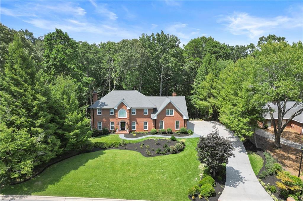 Welcome to 12010 Brookfield Club Drive—a beautiful 4-sided brick home offering 5 bedrooms, 4.5 bathrooms, and 4,600 square feet of stylish, updated living space. Ideally located within walking distance to both Brookfield Country Club and serene Lake Cherful in Mountain Park, this home blends refined comfort with outdoor fun.
Step inside to a freshly painted interior, gleaming new hardwood floors, and four cozy fireplaces. The spacious main level features a fireside family room with custom built-ins, a separate office/living room, formal dining room, and a large kitchen with a fireside breakfast nook/den. A sunroom with a full wall of folding glass doors opens to the entertainer’s deck, seamlessly connecting indoor and outdoor living.
Upstairs, the oversized primary suite is a true retreat with a spa-inspired bathroom and fully customized walk-in closet. You'll also find a convenient upstairs laundry room, a back staircase to the bonus room/bedroom, and two additional full bathrooms.
The finished terrace level offers flexible space for a media room, gym, home office, or guest suite. Outside, enjoy a large front yard perfect for games, and a fun backyard complete with a zip line and fire pit—perfect for evenings under the stars.
Additional highlights include brand-new double-pane windows, new water heater, newer roof, and HVAC. All in one of Roswell’s most sought-after neighborhoods! Conveniently located within miles to schools, shopping, restaurants and parks. Don't miss this one!