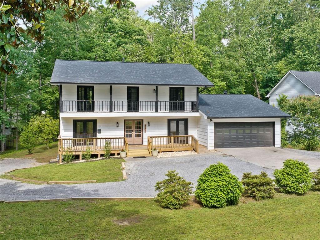 Don't miss this rare opportunity to own a beautifully updated, multigenerational or income producing home in one of East Cobb's most sought-after school districts! This spacious 5 bedroom, 4.5 bathroom home offers thoughtful updates and incredible flexibility for today's modern lifestyle. The main level features an open-concept main living area with an updated kitchen boasting quartz countertops that continue as the backsplash and ample cabinet space. You'll also find a private living space complete with its own bedroom, full bathroom, laundry hookup, kitchenette and a separate entrance-ideal for a guest suite, home office, or rental potential. Upstairs features 3 roomy bedrooms with ample closet space and 2 full bathrooms. Laundry is conveniently located upstairs for easy access. The fully finished basement is a true standout with its own private driveway, entrance, full kitchen with granite countertops, separate laundry, bedroom or office, and full bathroom. Whether you're accommodating extended family or looking for a strong income-producing setup, this space has it all. Brand new roof and ring cameras around the property.
