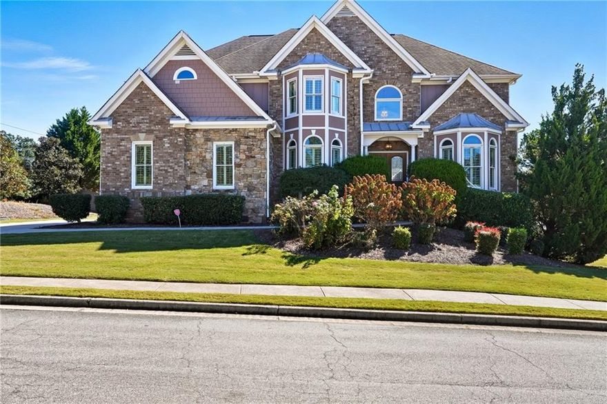 Presenting a stunning executive home in the heart of West Cobb!

This beautifully appointed residence offers 5 bedrooms and 4.5 baths across an open, elegant floor plan. Step through the grand two-story foyer and be greeted by an impressive entrance that sets the tone for the entire home. A formal dining room and executive office flank the entry, leading into the spacious living room with soaring 40-foot ceilings and abundant natural light.

The gourmet kitchen is a true showpiece—complete with a butler’s pantry, a large walk-in pantry, and an expansive island that flows seamlessly into the breakfast area and family room, creating the perfect setting for entertaining. The main-level guest suite offers privacy and comfort, ideal for in-laws or visiting guests. All main-level living spaces feature freshly re-stained hardwood floors for a refined touch.

Upstairs, you’ll find four bedrooms and three baths, including a luxurious primary suite with a sitting area, spa-like bath, oversized shower, and a massive walk-in closet. With over 4,000 finished square feet plus 1,500 sq. ft. of unfinished basement, there’s endless potential to expand or customize. Situated on a coveted corner lot, this home features a 4-car garage – three on the main driveway and a fourth connecting to the unfinished basement. The level and spacious yard offer endless possibilities for outdoor enjoyment and activities.

Perfectly located near top-rated schools, shopping, and dining—this West Cobb gem blends luxury, comfort, and convenience in one remarkable home. This executive home, crafted with 4-sided brick, stands as the original model for the community, showcasing unique and timeless design elements.