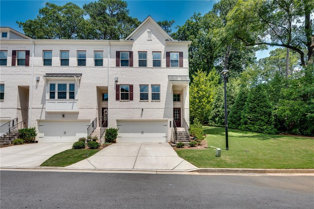 You won’t believe the space & abundance of light in this beautiful END-Unit townhome. Corner units rarely come on the market in this neighborhood and one with the double master floorpan is even more rare. This corner unit is 2-sided brick with an abundance of light and great views of the secluded back and side yards. It is WIFI certified including RING, WIFI Honeywell Thermostats and a Smart WIFI Dead Bolt, along with a wired Phoenix Alarm system that the new owner can activate with the security company of their choice. This home includes LVP on the main and lower levels, an open floorpan, large windows, over-sized family room and gas fireplace, huge kitchen island with white cabinets and granite countertops as well as a main level flex room/sunroom,. The lower level bonus space could be used as an office, games room or even an occasional overnight guest. The upper level includes a laundry room & 2 over-sized carpeted bedrooms each with an en-suite bathroom. The neighborhood is a hidden secret in 30329. Carramore Landing has less than 30 homes all built within the last 5 years. Residents enjoy a central green space with a community Gazebo along with the serenity of a smaller neighborhood. It is a quiet, gated community convenient to all the up-scale amenities you desire; close to I-85, Emory University Hospital, walking trails, dining, shopping and entertainment & only 25 minutes from Hartsfield International Airport. This home can’t be beat! Whether, you are looking for a home with an open floor plan and perfect for a roommate, or a home that has end-unit privacy along with beautiful grassy views & convenience, this low-maintenance End-Unit home could be what you’ve been searching for.