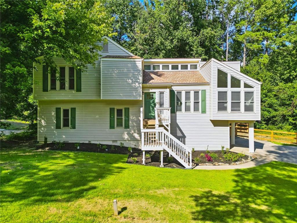 Sunlight, screened-in porch, FINISHED BASEMENT with walk-out access! What more could you want? Beautifully updated four-bedroom, three-bath home in the highly sought-after Pope High School district! Freshly painted inside and out, this residence offers an open layout with soaring ceilings and a cozy gas fireplace that’s perfect for gatherings. The modern kitchen is a showstopper, featuring granite countertops, brand-new cabinets with soft-close drawers, new appliances, and abundant storage. It connects seamlessly to the dining room and a bright breakfast nook that leads into a spacious sunroom with serene, picturesque views. Step outside to your private FENCED BACKYARD—ideal for your fur baby to run and play or for you to unwind and relax. A large deck and additional storage shed make outdoor entertaining and organization a breeze. The lower level provides a second living area with its own fireplace, an extra bedroom, and access to a beautifully renovated full bath. Additional features include a wet bar, a screened and covered porch, a dedicated laundry room, a garage with epoxy flooring and brand-new doors and openers, a vapor-barrier insulated crawl space, and peace of mind with a Trane HVAC system and 2021 water heater. With NO HOA and close proximity to parks, freeways, shopping, and dining, this home offers the perfect blend of comfort, convenience, and style.