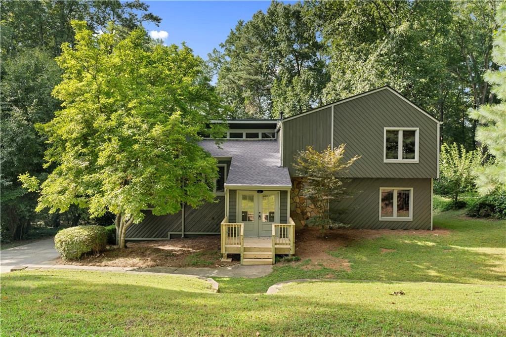 Beautifully updated split-level home offering 4 bedrooms and 3 bathrooms, perfectly blending modern style with functional living. The bright, open living room boasts vaulted ceilings and a cozy fireplace, creating a welcoming centerpiece for the home. The fully renovated kitchen features sleek white cabinetry, stainless steel appliances, and a stylish tile backsplash, with easy flow into the dining area. Spacious bedrooms include a serene owner’s suite with a private bath, while updated bathrooms showcase contemporary finishes and fixtures. A versatile bonus room provides extra space for a home office, gym, or media room. Enjoy outdoor living on the expansive new deck overlooking a private, wooded backyard. Additional highlights include a 2-car garage, fresh paint, new flooring throughout, and a prime location close to schools, shopping, and parks. Move-in ready and full of upgrades—this home is a must-see!
