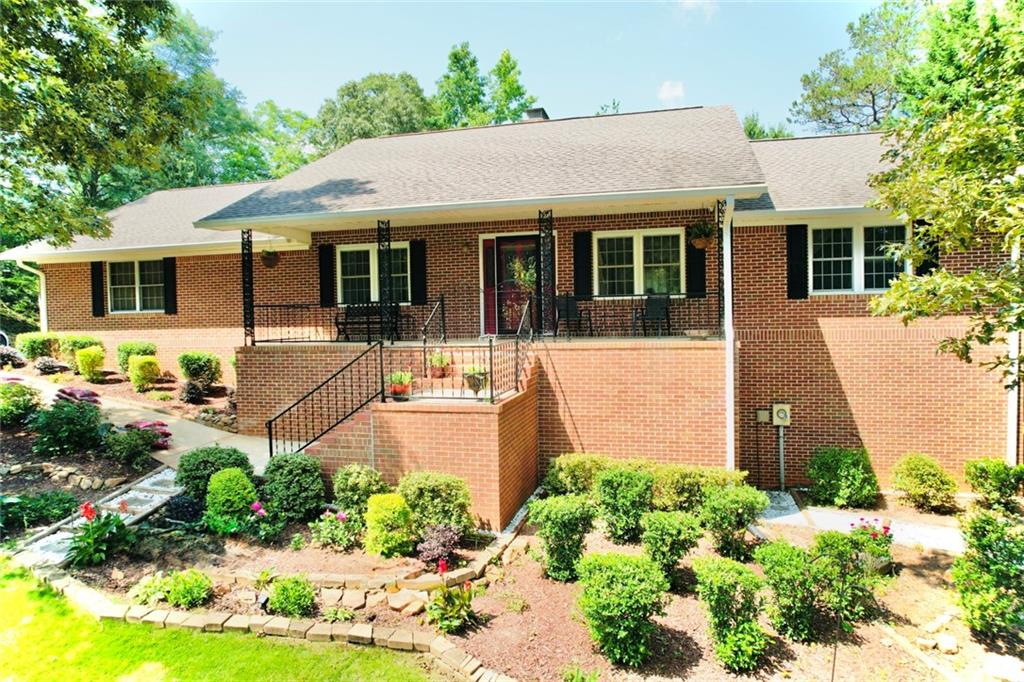 Well-maintained 3,444± sq ft brick ranch on 1+ acre with finished basement. Main level offers 3BR/2BA, galley kitchen with pantry & lazy Susan, and cozy living room with brick fireplace. Basement includes full in-law suite w/ 1BR/1BA, full kitchen, fireplace & private entrance—ideal for rental or extended family. Exterior features 2-car garage, 2-car carport, fenced yard, shed, well & county water, 220v for hot tub & generator wiring. Motivated sellers!