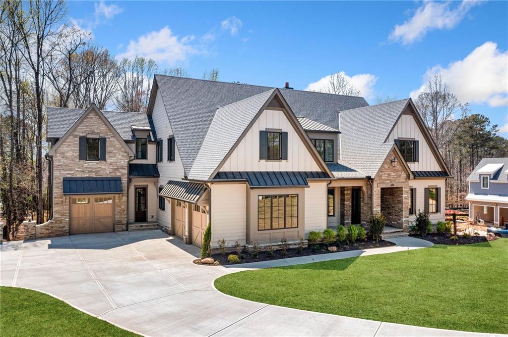 Welcome to Claxton, Chatham Neighborhood’s newest luxury community, located in the heart of Milton across from Bell Memorial Park. Claxton features 10 custom-built estate homes on spacious 1+ acre lots, thoughtfully designed and crafted by Vertical Luxury. This exclusive enclave offers unparalleled elegance, superior craftsmanship, and modern convenience in a picturesque setting. With a prime location and meticulously designed homes, Claxton presents a rare opportunity to experience luxury living in one of north Atlanta’s most sought-after communities. Timeless open floor plan features great flow and natural light making this home ideal for daily living and entertaining guests. The home features a well appointed trim package that includes built-ins, paneled walls, shiplap ceilings and beamed cathedral ceilings which are spectacular and PELLA windows and doors. The great room with fireplace and opens to outside living spaces. Owner's suite on main with spa like bathroom, with soaking tub, and a massive walk in closet. Spacious and stunning chef's kitchen with top of the line Thermador appliances, oversized island, quartz countertops and custom cabinetry and a scullery providing ample space for pantry storage, a mud room and a laundry room on route to the 3 car garage. Additional Ensuite Bedroom/Office on main level. Secondary level features 4 bedrooms with 4 full baths, a bonus room loft and second laundry room. Floored attic storage area. Terrace level has ideal layout for completion. Stubbed for bath. Expansive outdoor living area with fireplace, outdoor kitchen and dining area overlooking backyard which is ideal for a pool.