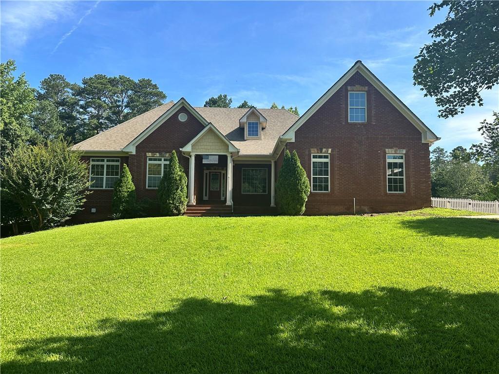 Beautiful brick home in Newton County. Master on main with trey ceilings, Master bath with spa tub, separate shower, separate vanities and walk in closet. Kitchen w/granite counter tops, custom kitchen cabinets, island containing sink, dishwasher, separate cook top and wall oven, breakfast area and walk in pantry. Kitchen opens to family room w/fireplace. Separate dining room. Hardwood floors throughout main living area. Upper-level suite with living room, bedroom, and full bath. Full unfinished basement with 95% of HVAC installed and Partial Bath. The septic is permitted for 1 bedroom/1 bath to be finished in the basement. We have a quote from contractor to finish basement and will share with a potential buyer. Covered deck off rear. Enclosed side yard with white picket fence. Main interior of the home has freshly painted walls and trim. Irrigation system.