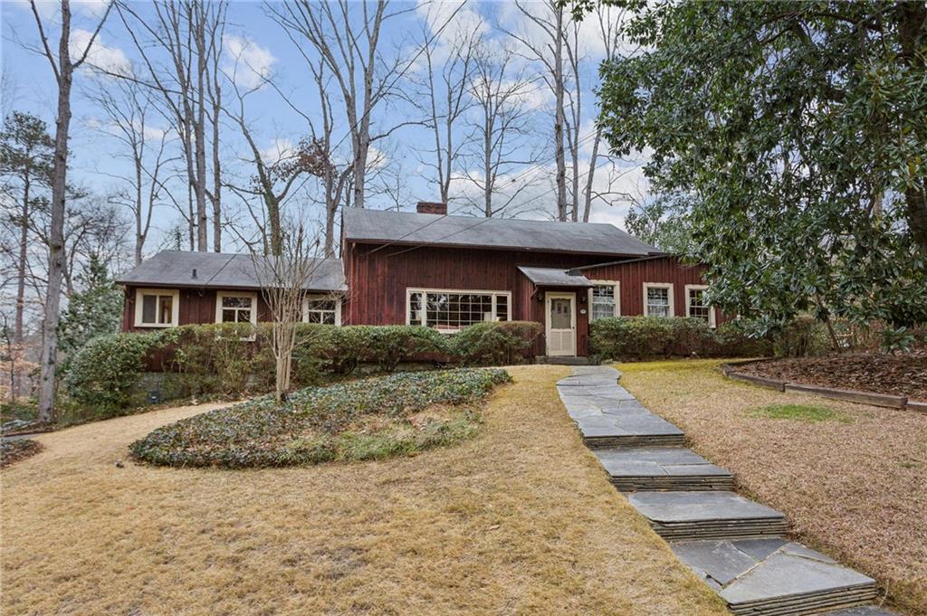 Such a special property! Believed to be one of the original farmhouses in Brookhaven, this home has been in the same family for over 60 years. It is a wonderfully charming home on approximately .70-acres nestled in the middle of Narmore Drive in Historic Brookhaven. This is a fantastic opportunity to renovate and make this house your own or build your dream home. The one-story home features gorgeous pine flooring throughout, as well as a spacious walk-up attic with a permanent staircase. The foundation is granite and the exterior is board and batten pine. The living room features a masonry fireplace surrounded by a wall of bookshelves and the dining room is large and can easily seat 10. The family room with brick fireplace features additional bookshelves plus a wall of glass overlooking the backyard and has access to the deck and covered patio. There is plenty of room in the kitchen for your breakfast table with beautiful views of the backyard. The primary bedroom has multiple closets and an en suite bathroom with double vanity. Two additional bedrooms are good-sized with hardwood floors under the carpet and share a hall bath. An additional small bedroom or office with full bathroom is located on the opposite side of the home. There is a drive-under, two-car garage with a storage area. The elementary school district is award-winning and the location is fabulous for shopping, restaurants, and groceries, plus easy access to major roads and highways. Home to be sold "as-is".