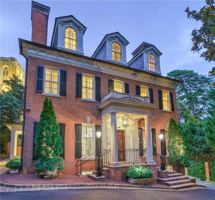 This impressive Buckhead home is tucked away behind a handsome brick wall, tall hedges and a security gate. Masterfully transformed for exacting owners through the vision of sought after architects Spitzmiller and Norris and landscape architect John Howard, this property has undergone a complete metamorphosis to offer unparalleled Intown living in a very private setting. Offering 6000+ SF on 4 floors, including 4 bedrooms, 4 full bathrooms and 2 half baths, the gracious floor plan spills off an exquisite foyer where there is easy access to the elevator and the spacious, beautiful rooms designed for formal and informal living. Outdoor lifestyle amenities include two covered limestone loggias, an endless lap pool and the most incredible gardens.
The property also features 3 garages, a whole house generator, custom Tischler windows and doors, automated window and door privacy shades, automated driveway turnaround, limestone patios and window ledges, custom iron railings and gates, slate roof, custom marble countertops and floors, 2 laundry rooms, dog bath, 3 fireplaces with antique mantles, whole house security/AV/sound system, loads of thoughtfully positioned storage and so much more! No detail was overlooked in the renovation, expansion and transformation of this special property.
