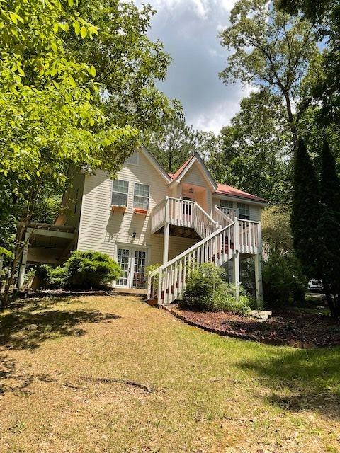Discover the perfect blend of charm, function, and flexibility in this updated property, designed to accommodate multi-generational living with ease. You will fall in love with this home nestled in a serene setting surrounded by nature yet only minutes from Gainesville and the Olympic Rowing Park at Lake Lanier. This home offers peace, privacy, and winter lake views—all just minutes from town! The house features two-in-law suites, hardwood floors, and everything that nature has to offer. One of the in-law suites is a one-bedroom, one bath and the other is a studio. Both have their own kitchens. The Upstairs floor features two bedrooms, a full kitchen, and one full bath. All bathrooms are newly updated. Recent updates also include stainless steel appliances upstairs, fresh paint throughout, new flooring in in-law suites, new HVAC system downstairs, painted kitchen cabinets, repaired deck, and more! Every area is designed with comfort in mind, offering private kitchens and baths—ideal for in-laws, extended family, or even rental opportunities. This home is very practical and offers plenty of outdoor space, privacy, and tranquility.