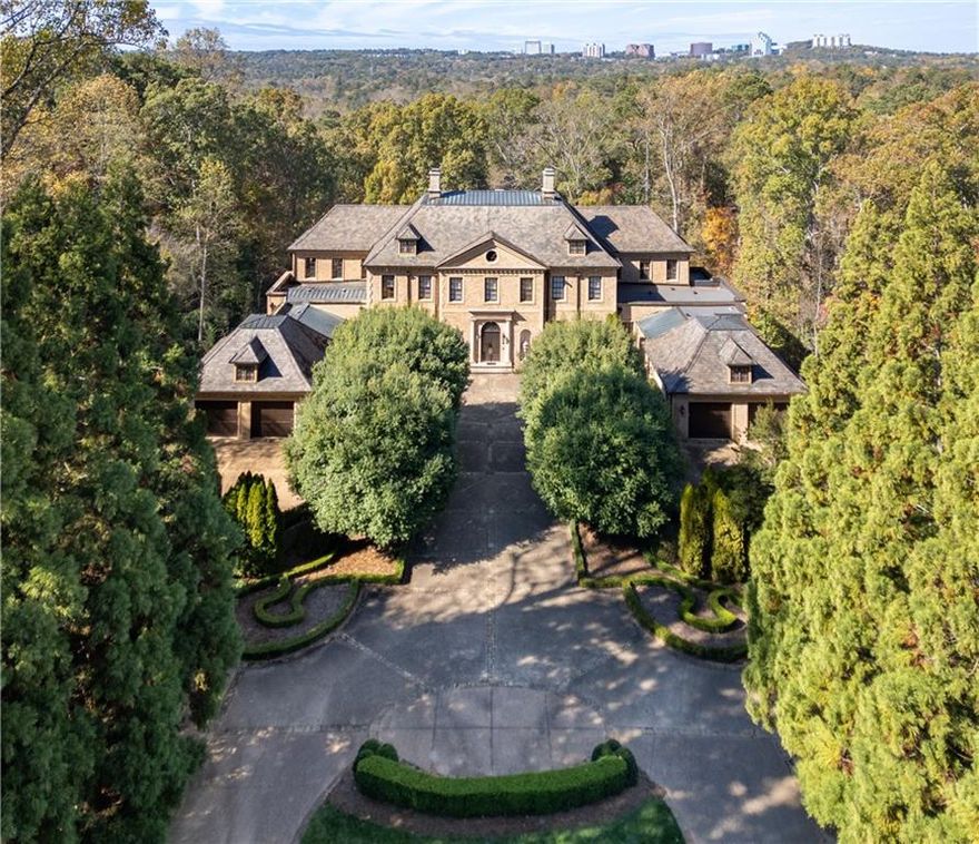 "Evergreen" estate  is set on a ridge-top lot above the city in the Paces neighborhood, close to dining, shopping, and top-rated schools...all while feeling worlds apart. A grand gated entrance framed by an allée of evergreens reveals 3.7 acres of perfectly manicured lawns, formal gardens, stately mature oaks, a charming potting shed and abundant parking. The backyard is a private oasis, with a picturesque pool complemented by 2 separate pool houses - each with disappearing sliding doors that seamlessly blend indoor and outdoor spaces; one equipped with a full kitchen, elevating the outdoor living experience to an exceptional level. 

Main Level - 

The domed grand foyer introduces you to the sophisticated elegance within, featuring meticulously crafted details and soaring 12+ foot ceilings. Every detail has been thoughtfully designed to offer the ultimate in luxury, comfort, and function. The entry hall offers the perfect setting for entertaining on a grand scale. A discreet full bar with a service window enhances the home’s capacity for hosting. French doors open to a sun-drenched terrace and pool area—an ideal space for both intimate gatherings and large celebrations.
The main level includes a spacious family room, an elegant library lined and topped with rich paneling, a formal fireside dining room, and an expansive living room. Other amenities include an elevator to all floors, 2 laundry rooms, two 2-car garages, extensive guest parking, two generators and 7 fireplaces!

The light-filled kitchen is a true culinary haven, fully renovated with marble counters, Wolf appliances, dual ovens plus a steam oven, dual refrigerators, dual dishwashers, an oversized center island, and a butler’s pantry. The adjoining keeping room opens to a cozy fireside screened porch overlooking the oasis beyond, perfect for year 'round enjoyment.
Bedroom Suites - 
Two stunning primary suites (one on the main level), each with lavish bathrooms with walk-in showers, soaking tubs, expansive closets, and custom dressing rooms. In total, the home includes 6 spacious bedrooms, 6 full bathrooms, 6 half baths, plus a full in-law suite apartment w/a separate entrance. 


Terrace Level - 
The unique daylight terrace level features its own side entrance and parking area for staff or guests. A grand central hall with 14' high ceilings is lined with offices and boardroom spaces that can easily be converted to whatever your heart desires. Perfect for a home-based business with staff, this space was previously an indoor basketball court and can easily be converted to a golf simulator, bowling alley, indoor sport court or all of the above! At the far end end is a large window-lined room with a full kitchen, storage, and bedroom with private outdoor access - perfect for extended family, an au pair or live in staff. A separate recreation room with a bar would be the perfect spot for an incredible media room! 

With a setting beyond compare and a home like no other, this is an incredible value opportunity for the next owner to make it their own.