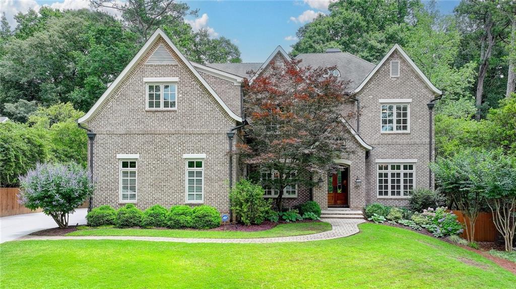 Executive 4-sided brick home on the coveted Lake Forrest Lane in Chastain Park Buckhead is a masterpiece in design & craftmanship which features 7 bedrooms and 7 bathrooms on a level lot. Spacious foyer leads to an elegant formal dining room and a French-paneled living room which can be repurposed as an office. Fabulous floorplan with a thoughtful open layout is great for entertaining. The chef's kitchen with large, honed leather granite island is the heart of the home. The kitchen opens to the bright everyday dining room and the spacious family room which features designer coffered ceiling, fireplace, and French doors leading to the serene sunroom with a cozy wood fireplace, slate floor, and wood panel ceiling overlooking a large private and fenced backyard. Butler's pantry, fully outfitted with cabinets, sink, wine cooler, and beverage refrigerator along with walk-in-pantry, mud room with large cabinets and built-in shoe drawers off the 3-car garage with EV charging station are also on the main level. Guests will enjoy the convenience of a bedroom suite with a full bathroom on the main as well. Upstairs presents a divine owner’s suite with antiqued mirror foyer, unique barrel ceilings, Francois fireplace flanked by built-ins, French doors leading to a spacious private walk-out slate balcony, custom walk-in closet, and an opulent en-suite marble bathroom with a soaking tub and separate glass shower. Upstairs you will find four additional bedrooms and three full bathrooms, laundry room, and home management office with tasteful built-ins. Fully finished terrace level features an au pair suite with private patio and entry, multiple sitting and recreation room areas, and expansive storage. Welcome to the gorgeous turn-key home walking distance to Buckhead’s most cherished and vibrant community Chastain Park with its golf course, arts center, walking trails, baseball fields, swimming pool, playground, amphitheater, equestrian center, restaurants, and more… Life worth Living! Call us for a private tour.