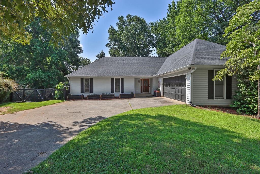 BRAND NEW ROOF Just installed June 2025! Come and see this extra large 4 bedroom, 3 and a half bath ranch home walking distance to Lake Lanier! Recently remodeled walkout basement has a second master bedroom complete with master suite, a second kitchen, living room, office space and a workshop! One level living on both floors! Perfect for a teen suite, in-law suite or rent it out for extra income! Main floor has Hardwood floors throughout and still in great condition! Master bedroom has direct access to the large 2 story deck overlooking the spacious and private fenced in backyard perfect for gardening and pets. With no HOA and lots of options for storage for RV or water toys. Close to highways, shopping and schools and of course Lake Lanier!