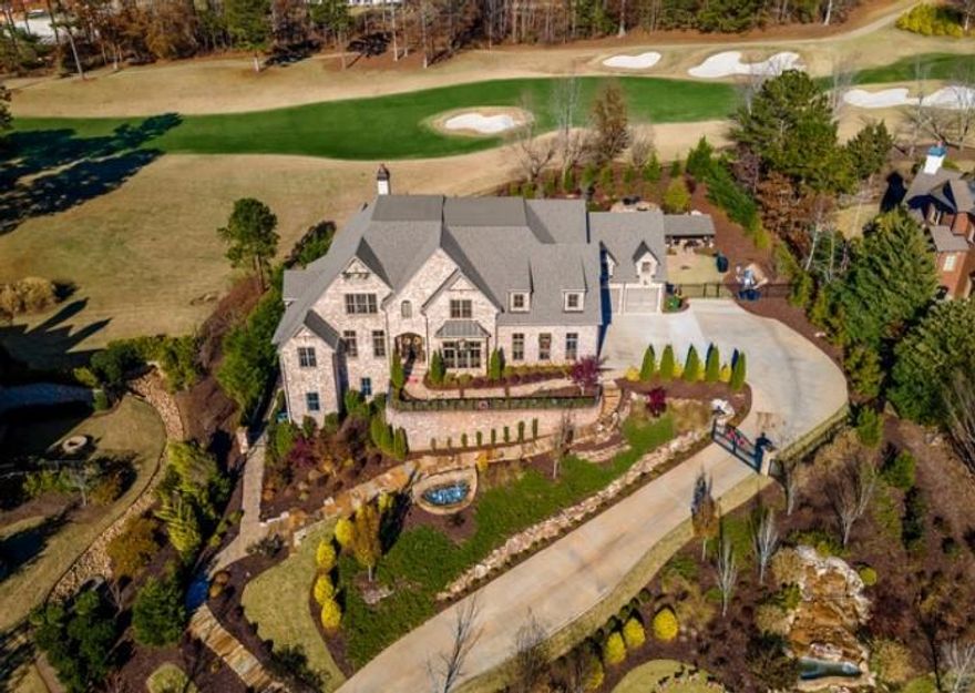 An Unrivaled Showcase of Luxury Living!
Welcome to a true masterpiece of design and craftsmanship—this extraordinary custom estate redefines luxury living, perfectly positioned on the 8th hole of the prestigious Manor Golf & Country Club, a 24-hour guard-gated community offering both exclusivity and serenity.
From the moment you enter, you're greeted with expansive, light-filled living spaces that blend elegance and comfort. The main level centers around a chef’s dream kitchen, featuring two oversized islands, top-of-the-line appliances, a walk-in pantry, and an open layout that seamlessly flows into the grand family and living rooms.
Step into the enclosed lanai and take in sweeping golf course views  and the stunning resort-style, heated saltwater pool, complete with a swim-up bar,two stone waterfalls, and a spa—your personal oasis of relaxation and entertainment.
When it's time to host in style, ride the elevator down to the ultimate 5,100 sq ft terrace level, thoughtfully designed for luxurious entertaining. Highlights include:
A 12-seat state-of-the-art theater 
A massive 800 sq ft fitness center
Two bathrooms, 12 seater sauna, 6 seater steam room, Jacuzzi
Private guest suite and office, or turn it into a play room.
A spacious billiards/recreation area
A custom-designed pub-style bar
And for the connoisseurs, a cellar crafted with bourbon and whiskey lovers in mind, offering a refined retreat where your collection can be appreciated in style.

The main-level primary suite is a true retreat, showcasing soaring double tray ceilings and breathtaking views of the golf course, all bathed in natural light. It opens directly to the covered lanai, blending indoor comfort with outdoor serenity. The spa-inspired en suite bathroom is pure indulgence—featuring a freestanding soaking tub, an oversized walk-in shower spacious enough for the whole family, dual vanities, dual water closets, and dual custom walk-in closets. And for that extra touch of elegance, there's a beautifully appointed glam vanity—perfect for morning routines or evening prep in your own private sanctuary.

Every detail has been thoughtfully designed to offer both luxury and functionality in one of the most stunning owner’s suites you’ll find.
Upstairs, you’ll find 2 additional master suites,  2 en suite baths in all secondary bedrooms, a massive loft area and office/upstairs family room/office with a picture window overlooking the 8th hole.
Additional features include beautiful hardwood flooring throughout and an additional attic closet—ideal for those who crave even more space.
and an 8-car garage, perfect for your automotive collection. Already approved are plans for a garage expansion with a two-bedroom, two-bath loft and glam barber studio.
This estate isn’t just a home—it’s a lifestyle, meticulously designed for those who appreciate luxury, privacy, and exceptional living.