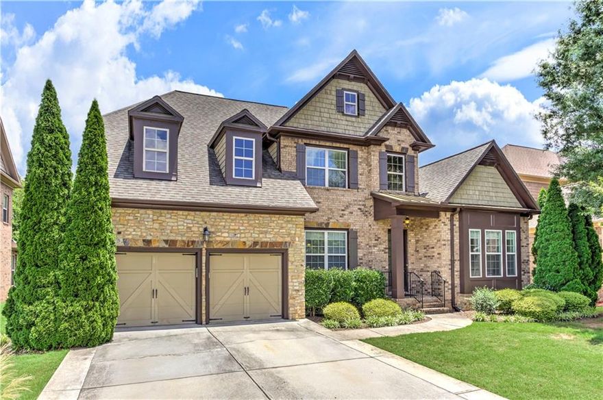 Beautiful 3-sided traditional brick home located in desirable Jamerson Estates.  10+ ft. ceiling, detailed crown molding, a massive open floor plan, hardwood floors make this spacious home a truly functional home.  As you walk into the main foyer of the home you have a formal living room/home office area, and a large formal dining area perfect for entertaining and hosting a large group. The main level has an owner’s suite with a whirlpool bath, separate shower, double sinks, and a spacious walk-in closet.  An additional ensuite bedroom with a private full bathroom is conveniently located on the main level of the home.  2 bedrooms on the main level make this a very unique feature of the home's layout.  The kitchen is large with stainless steel appliances, gas range, double ovens, a large island with an eat in kitchen area that overlooks the deck and backyard.  The kitchen opens to the large family room with a gas fireplace and a stereo system.  Off of the garage is a mud room which opens to a laundry room.  The upstairs offers two additional bedrooms with a jack and jill bathroom, and a large loft area, ideal for a sitting room, play area, or flex space let your imagination make this space the best use for your use.  The full basement includes two oversized workshop/storage areas that can easily be converted into additional bedrooms, offices, or living space. A large bedroom with a full bath is located in the basement, offering potential for a full in-law suite conversion. Enjoy outdoor living with a level lot, upper deck, and a second deck off the basement level, perfect for entertaining. Located in a quiet, established neighborhood with a walking trail, top-rated schools, and easy access to shopping, dining, and parks.  Close to I-575, and Hwy 92 with easy access to GA400.  Take the time to see the possibilities this home will offer you.