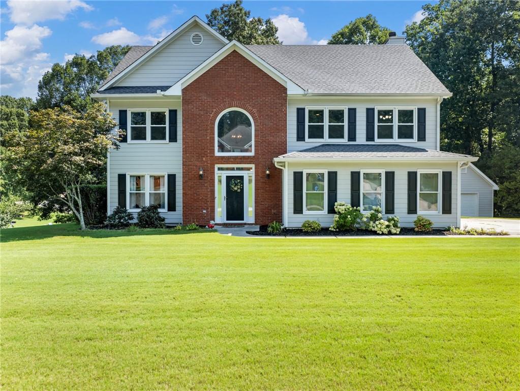 Gorgeous 5 bedroom 2-and-a-half-bathroom home located in the heart of Dacula. This well-maintained home offers an open floor plan, hardwood floors throughout the main floor, separate dining room, office or play area for the kids. The staircase with rod iron balusters brings you to the 2nd floor where your spacious master bedroom with vaulted ceiling is located. The master bathroom with a separate water closet offers privacy and comfort to the home. Two spacious bedrooms offer large closets and built-in bookshelves great for the kids' books or perfect for the home office plus two additional spacious bedrooms. The house is situated on a large lot with professional landscaping. Bonus! Outbuilding with air conditioning and electricity! Great for a workshop, man cave or just for extra storage. Perfect home with perfect location, rare find! A must-see home in Dacula and sought after Mill Creek School District!