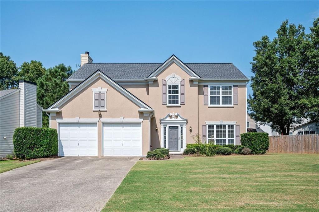 Welcome to this charming two-story home featuring a grand two-story foyer and a bright, open floor plan. The spacious family room boasts a cozy gas fireplace and flows seamlessly into the eat-in kitchen, complete with a center island, white cabinetry, newer stainless steel appliances and new flooring. Enjoy formal gatherings in the separate dining room, which opens to a light-filled living room—perfect for entertaining guests. Upstairs, you'll find all bedrooms including the primary suite with a large walk-in closet. The primary bathroom offers a double vanity, garden tub, and separate shower. Convenient upstairs laundry room with washer and dryer included. Step outside to a private, fenced backyard with a wood privacy fence and a patio—ideal for outdoor relaxation or play. Located on a quiet cul-de-sac street in Chastain Glen, a swim/tennis/playground community with no rental restrictions. Just minutes to I-75 and I-575, Kennesaw State University, shopping, dining, and more! Don't miss this move-in ready home in an unbeatable location! Roof is 5 years old. Upstairs HVAC replaced July 2022.