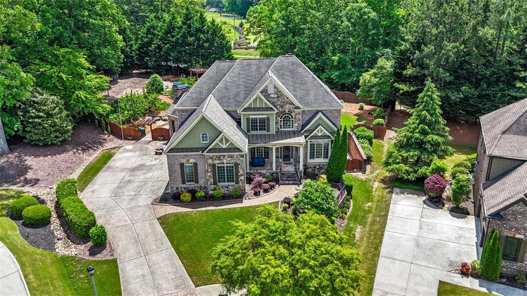 Tucked away on a quiet cul-de-sac, this beautifully crafted home offers refined living across three finished levels. Designed with high-end features including extensive trim work, crown molding, built-ins, gleaming hardwood floors, coffered ceilings, arched windows, and CAT5 wiring with central vacuum throughout. The gourmet kitchen is a chef’s dream, featuring premium stainless steel appliances, Cambria countertops, a breakfast bar, wine rack, plate rack, abundant cabinetry, built-in desk, and generous serving space. A large breakfast area flows seamlessly into the cozy fireside keeping room — perfect for casual gatherings. The main level includes a guest bedroom and full bath, ideal for visitors or a home office. Upstairs, you’ll find the luxurious master suite with a sitting area, fireplace, and an expansive walk-in closet. Three additional bedrooms, two full bathrooms, and a media room complete the upper level. The finished terrace level offers the same high-quality finishes and includes a spacious recreation room, bedroom, full bath, and multiple unfinished areas ready for customization or storage. Outdoor living is a true highlight of this home! Step out to the screened-in porch and enjoy the professionally landscaped backyard featuring a fireplace, multiple seating areas, walkways, a pergola, and a stunning 32-foot waterfall. There’s even plenty of room to add a pool or enjoy lawn games. Located in a desirable community with top-notch amenities including a pool, clubhouse with catering kitchen, fitness center, tennis courts, and playground. Zoned for the brand-new Seckinger High School, this home truly has it all.
Don’t miss the chance to make this pristine, move-in-ready home yours — it’s a must-see!